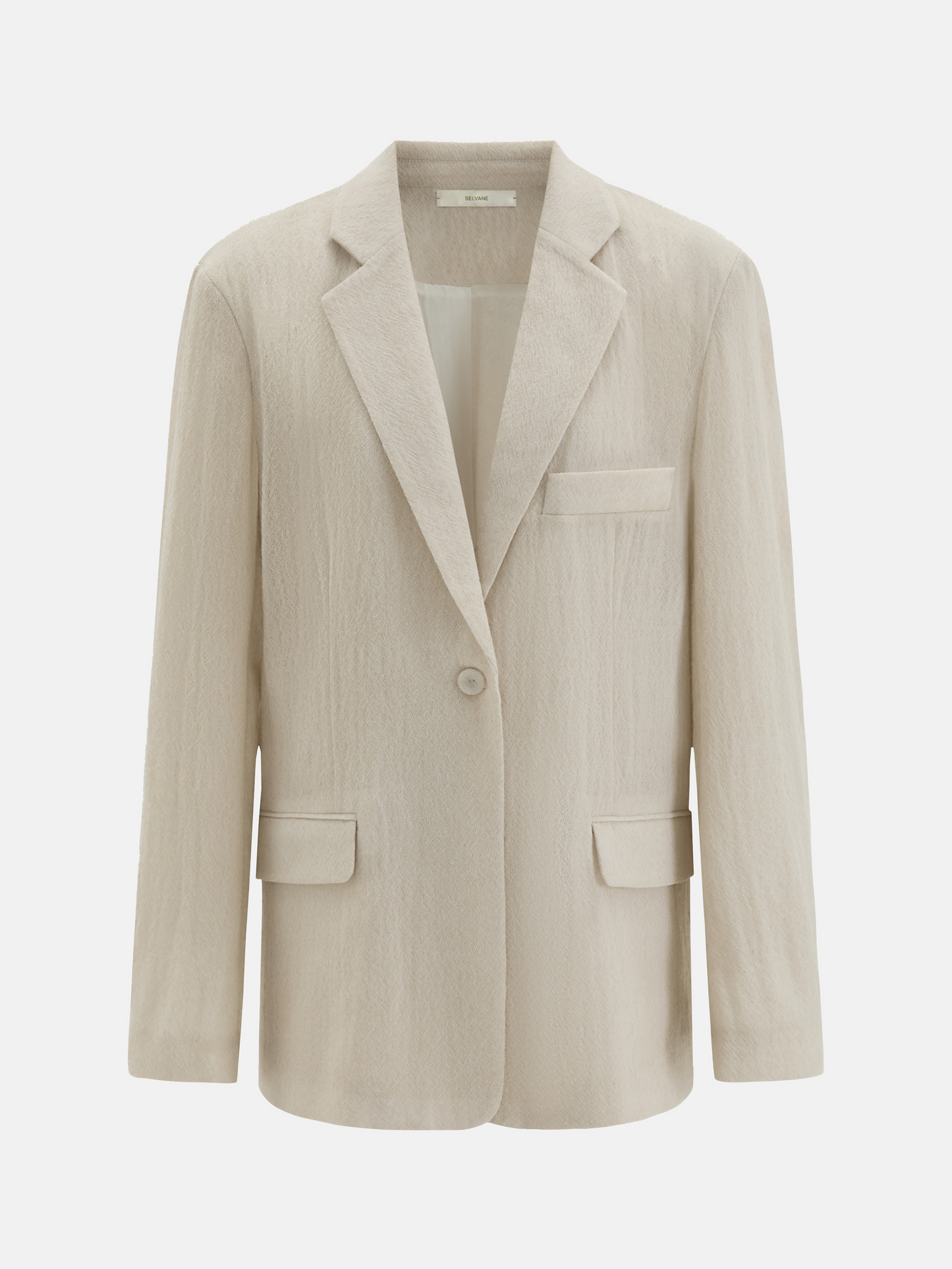 Structured worsted wool jacket with mulberry silk lining, tailored fit, shown on a model in a thoughtful pose.