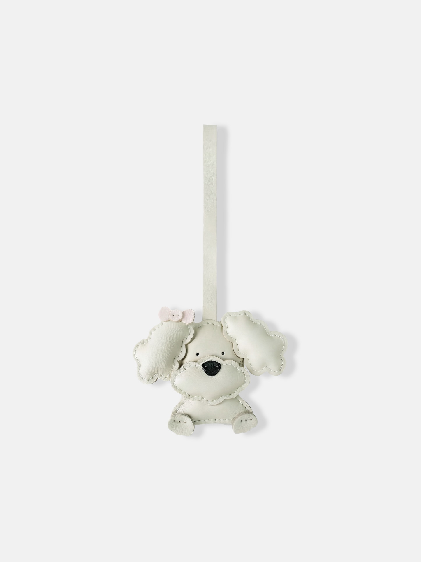 Selvane Bow Poodle bag charm in minimalist leather, featuring a sculpted poodle figure with a small, precise bow.