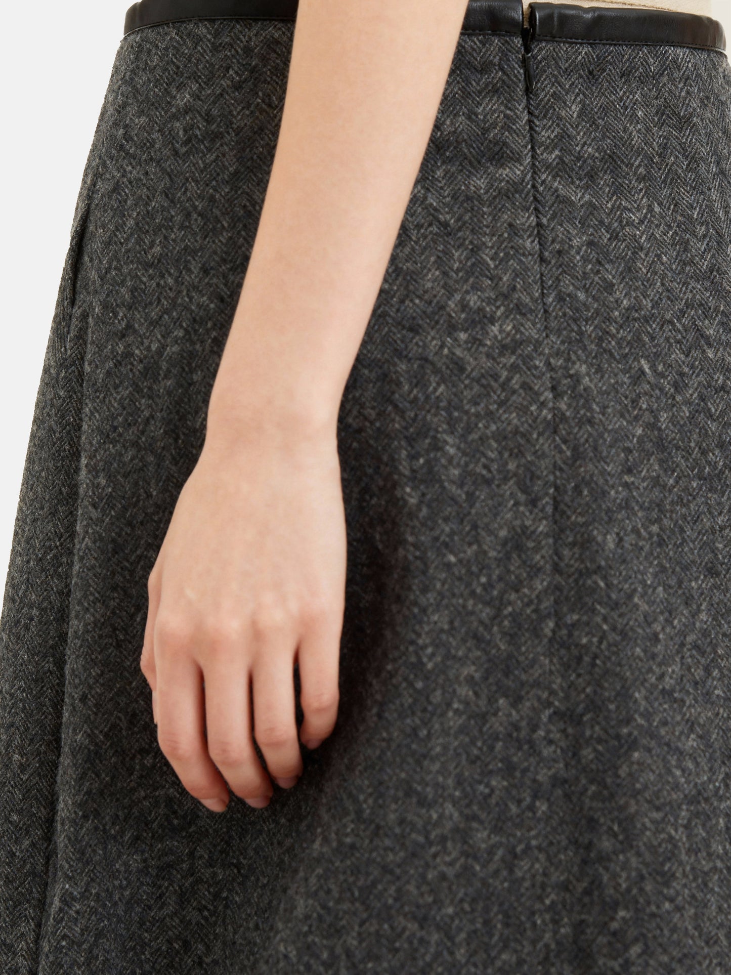 Charcoal wool-blend two-piece set featuring a cropped, boxy jacket with a sharp faux-leather contrast collar and a clean straight skirt.