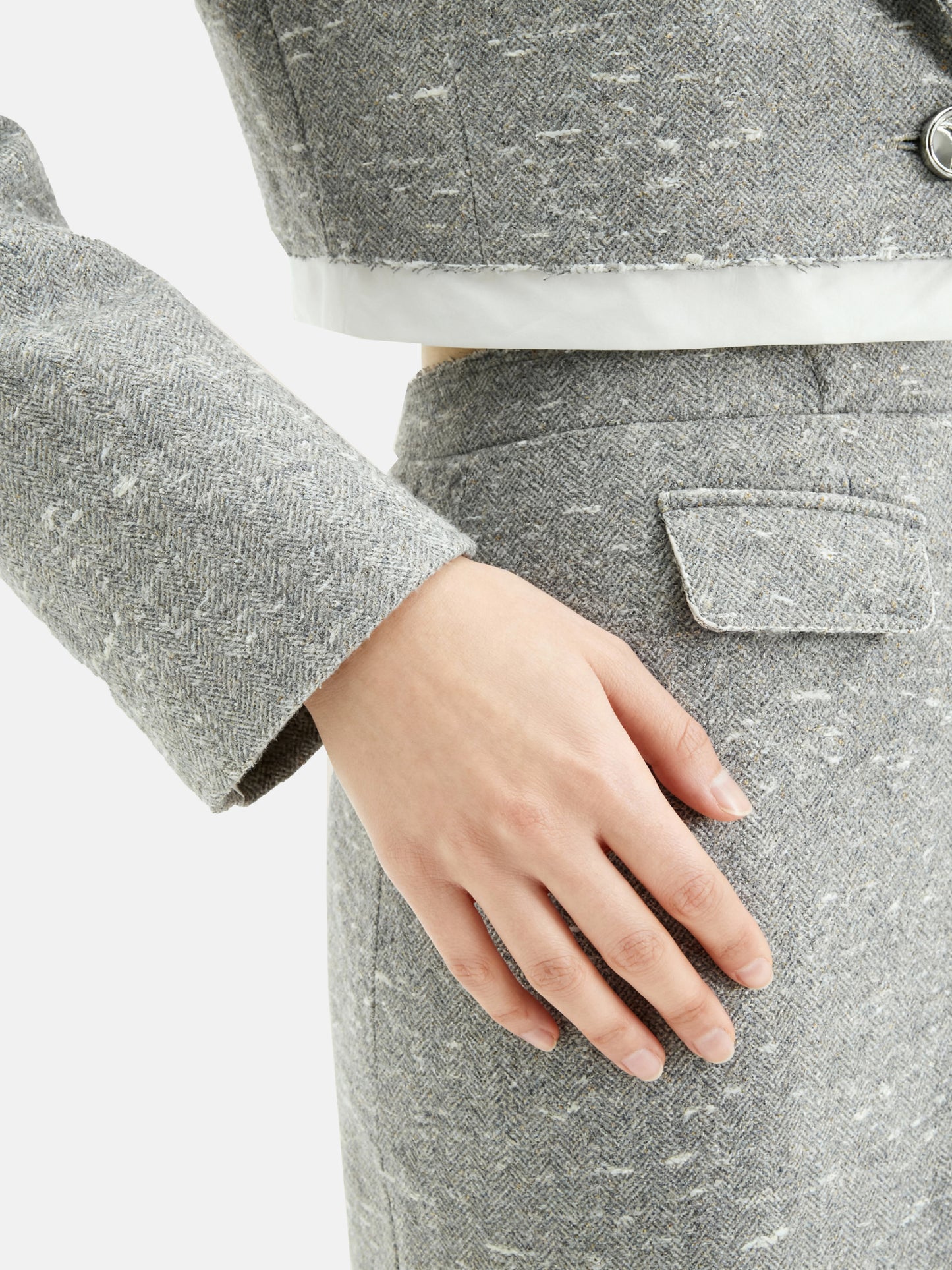 Cropped blazer and wrap midi skirt set in grey, featuring disciplined shoulders and fluid lines, inspired by volcanic terrain.