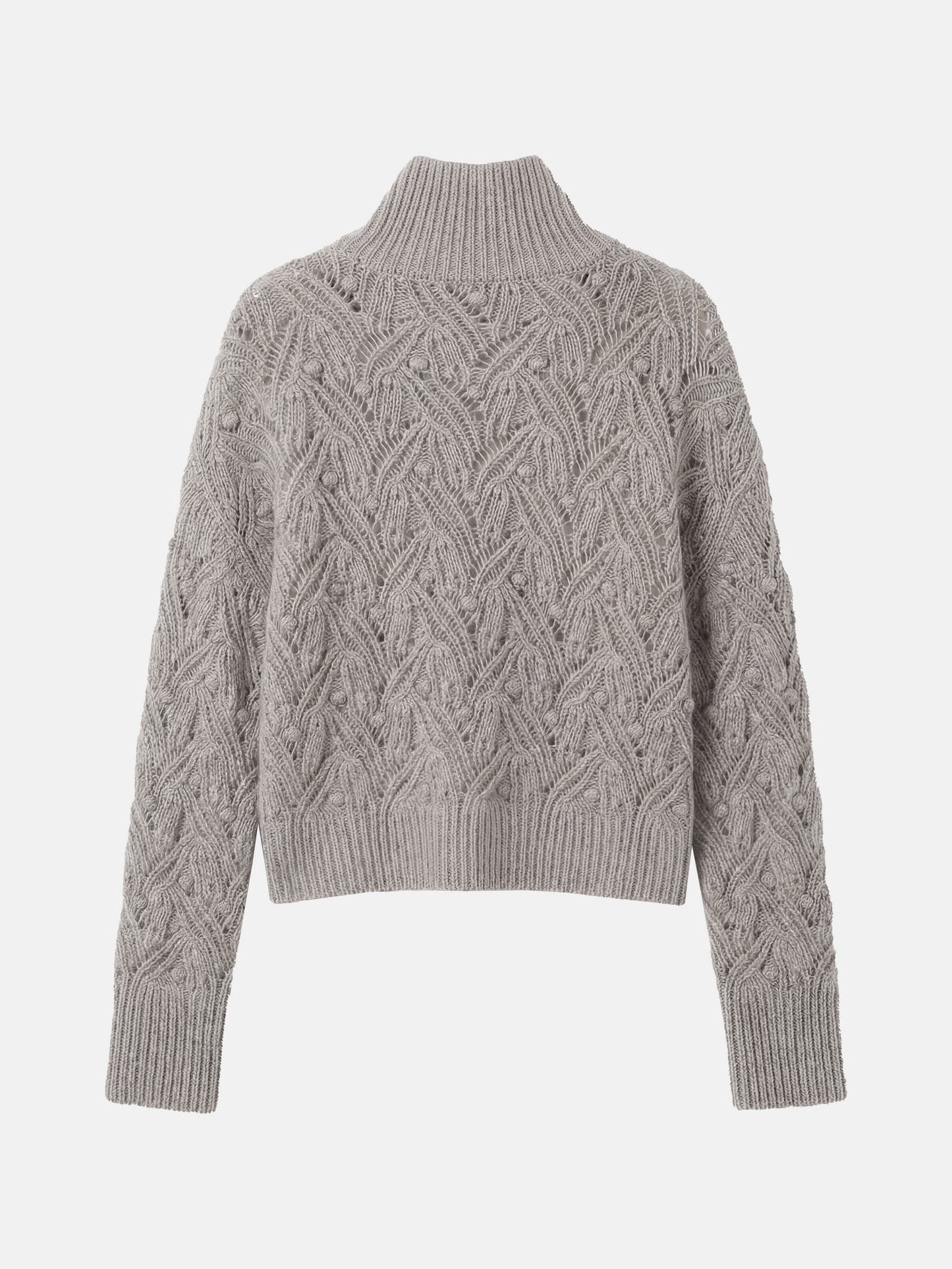 Cropped soft grey cashmere mock-neck cable sweater with sculpted texture, shown on a model, conveying quiet warmth and refined presence.