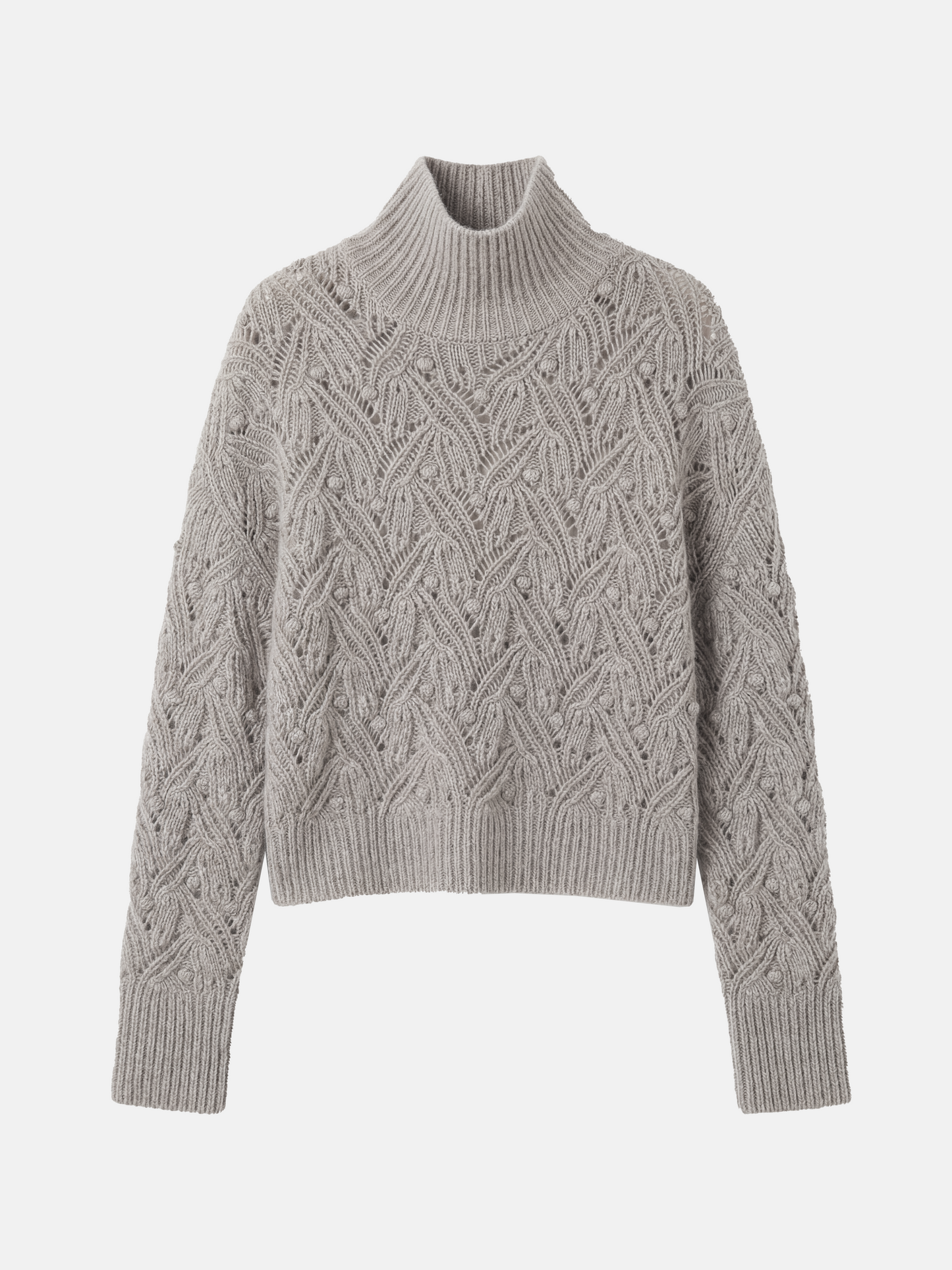 Cropped soft grey cashmere mock-neck cable sweater with sculpted texture, shown on a model, conveying quiet warmth and refined presence.