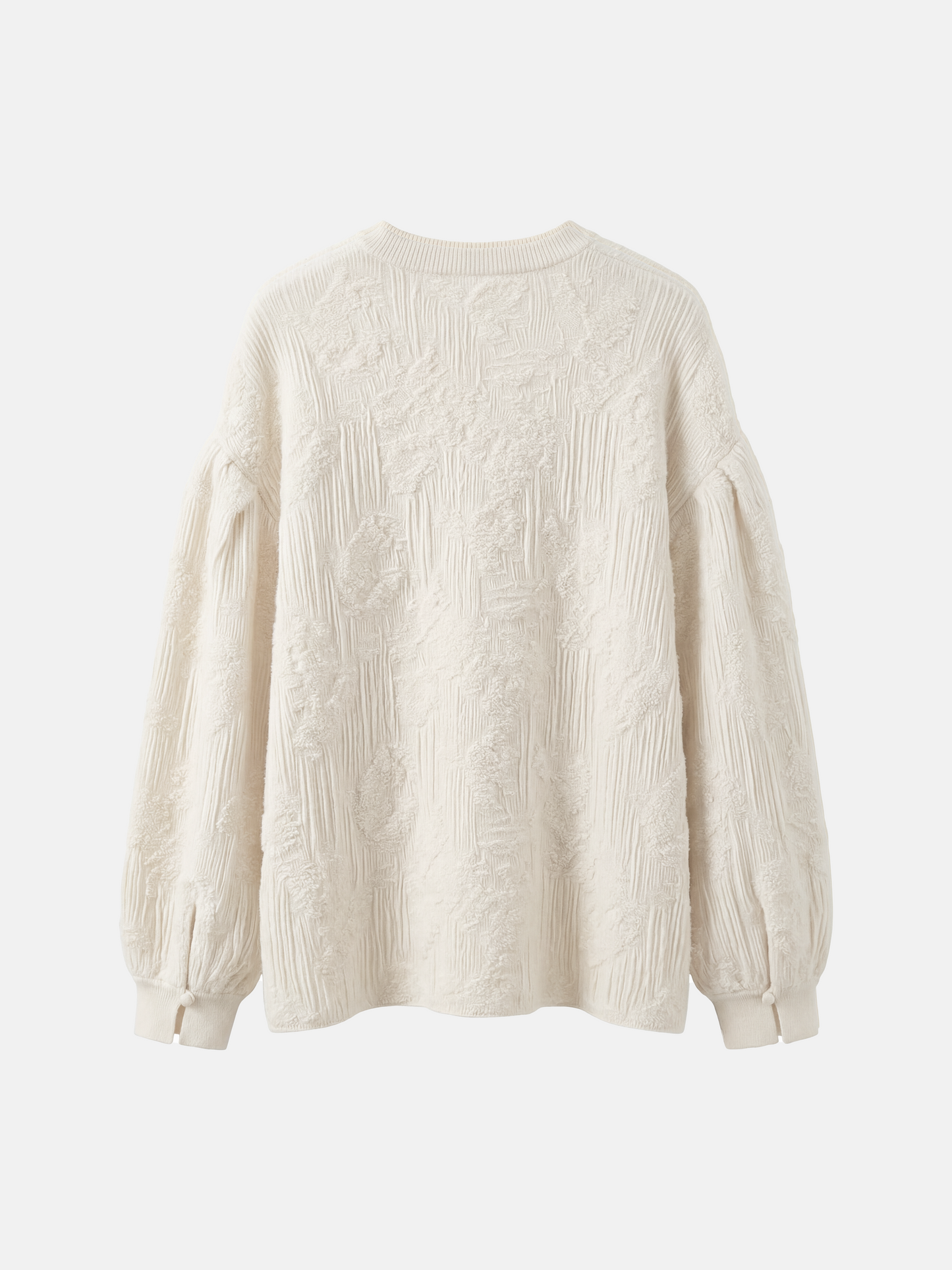Relaxed ivory cashmere knit top featuring a clean round neck, deep slit, soft volume sleeves with neat cuffs, and a distinctive raised texture.