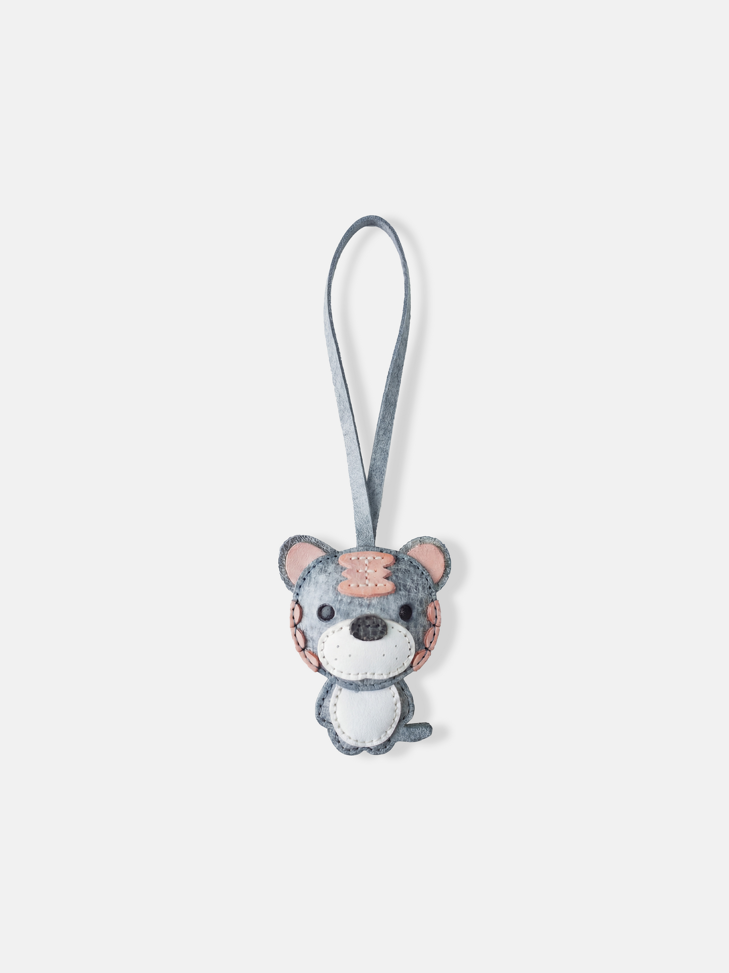 Hand-stitched leather Selvane Tiger Bag Charm, showcasing a playful yet fierce, bold, and compact design.