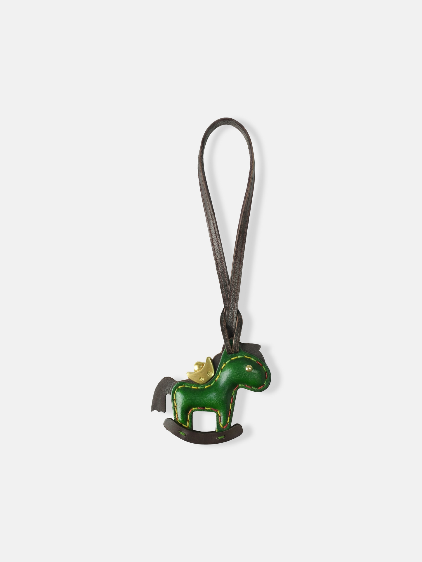 Deep green leather rocking horse bag charm with a gold-tone crown, compact and graphic, attached to a bag.