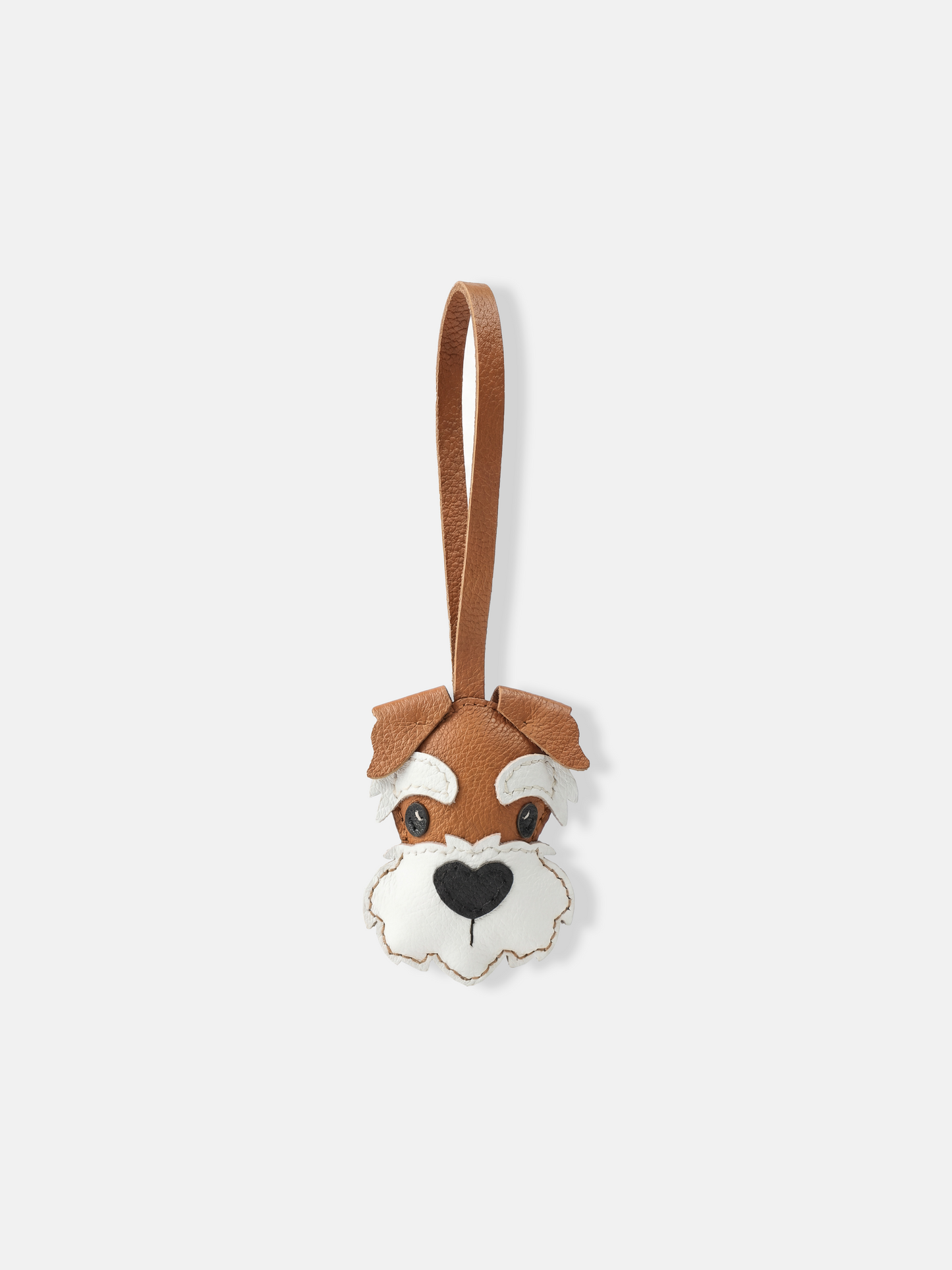 Selvane Schnauzer Face Bag Charm in layered leather, featuring sharp ears, arched brows, and a sculpted beard, with a slim strap for vertical elegance.