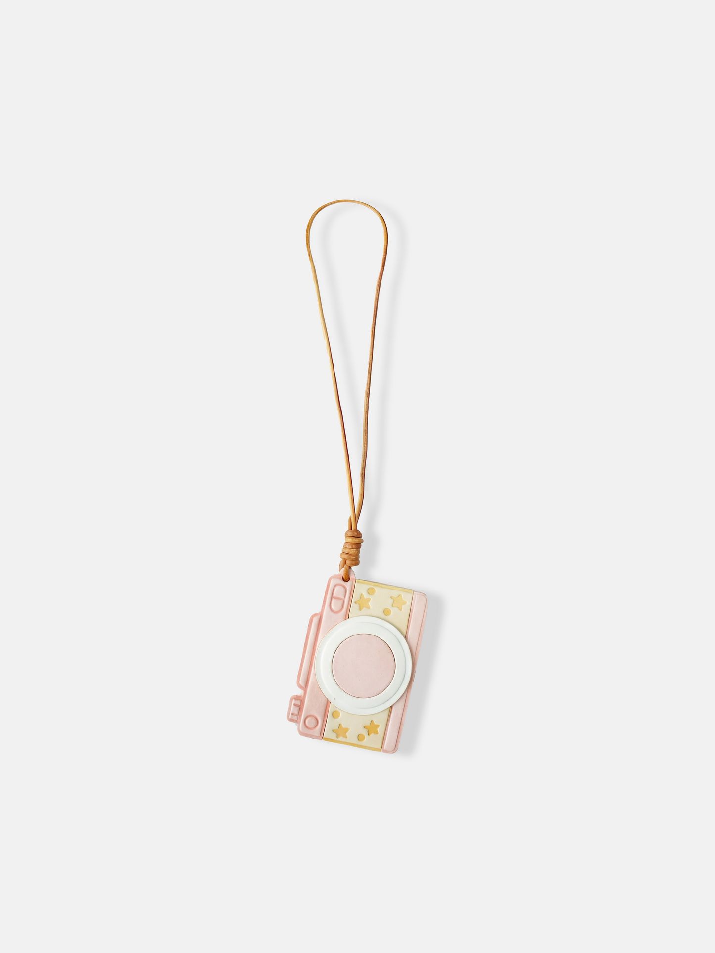 Selvane Retro Camera Bag Charm featuring a graphic, pocket-size silhouette with a bold circular lens, squared edges, and playful star detailing, attached to a long strap.