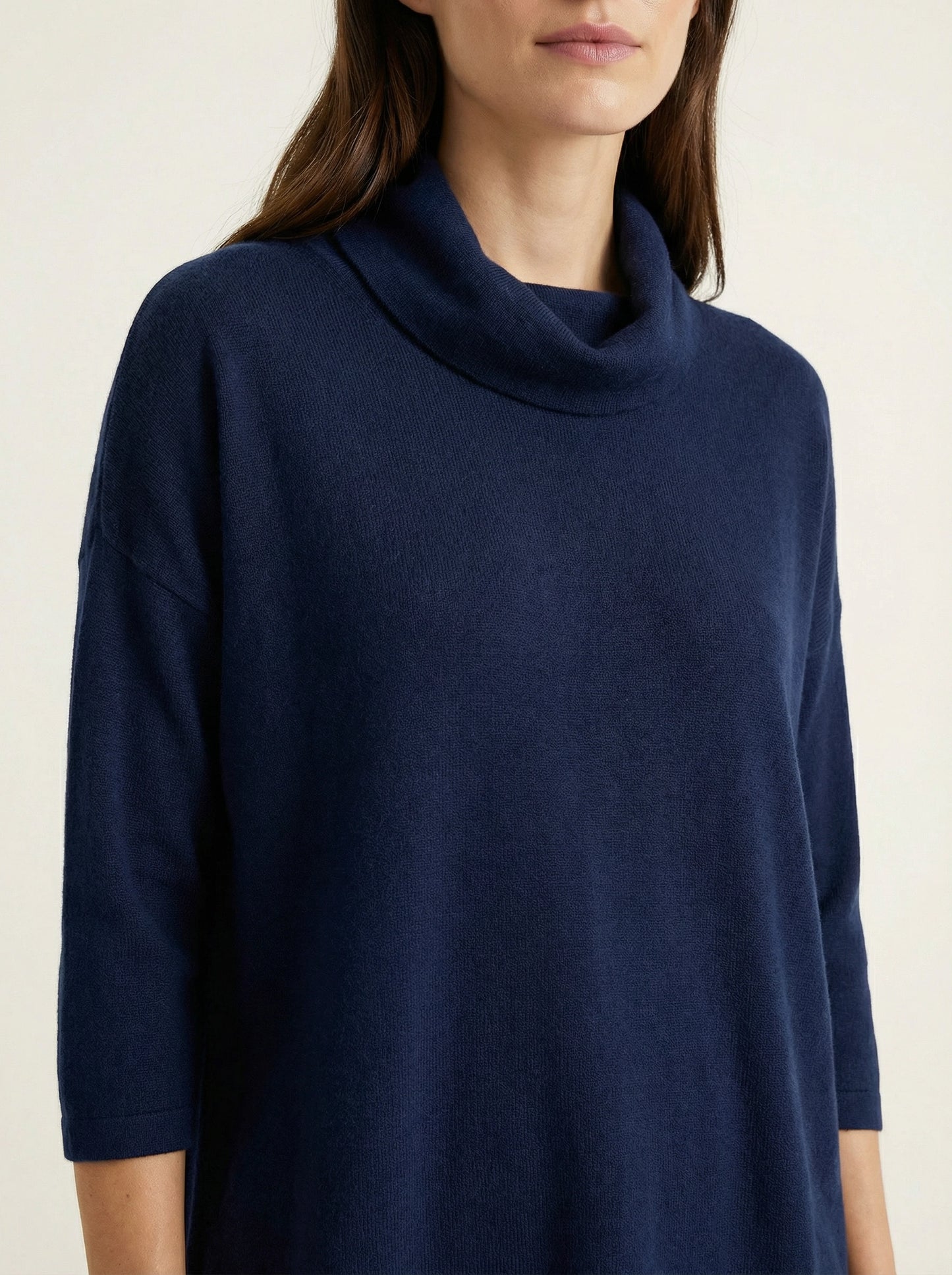 Model wearing a deep navy Tencel-blend cowl-neck top and matching midi pencil skirt set, styled elegantly.
