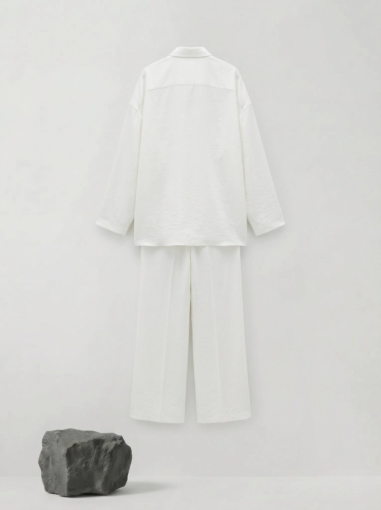 SELVANE pure white bow-tie blouse and wide-leg trousers set in luminous, crinkled acetate fabric, styled elegantly.