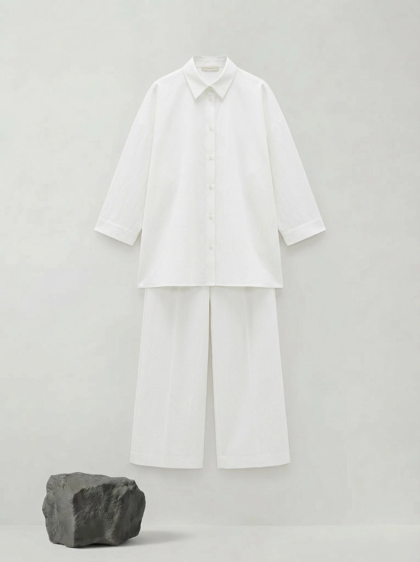 SELVANE pure white bow-tie blouse and wide-leg trousers set in luminous, crinkled acetate fabric, styled elegantly.