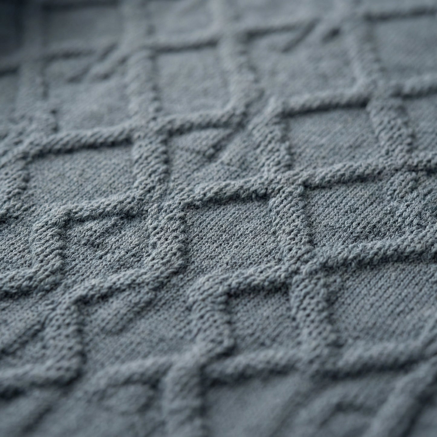 Sleeveless SELVANE Jacquard Knit Tank in muted grey-blue, featuring intricate diamond pattern, horizontal stripes, scoop neckline, and ribbed hem.
