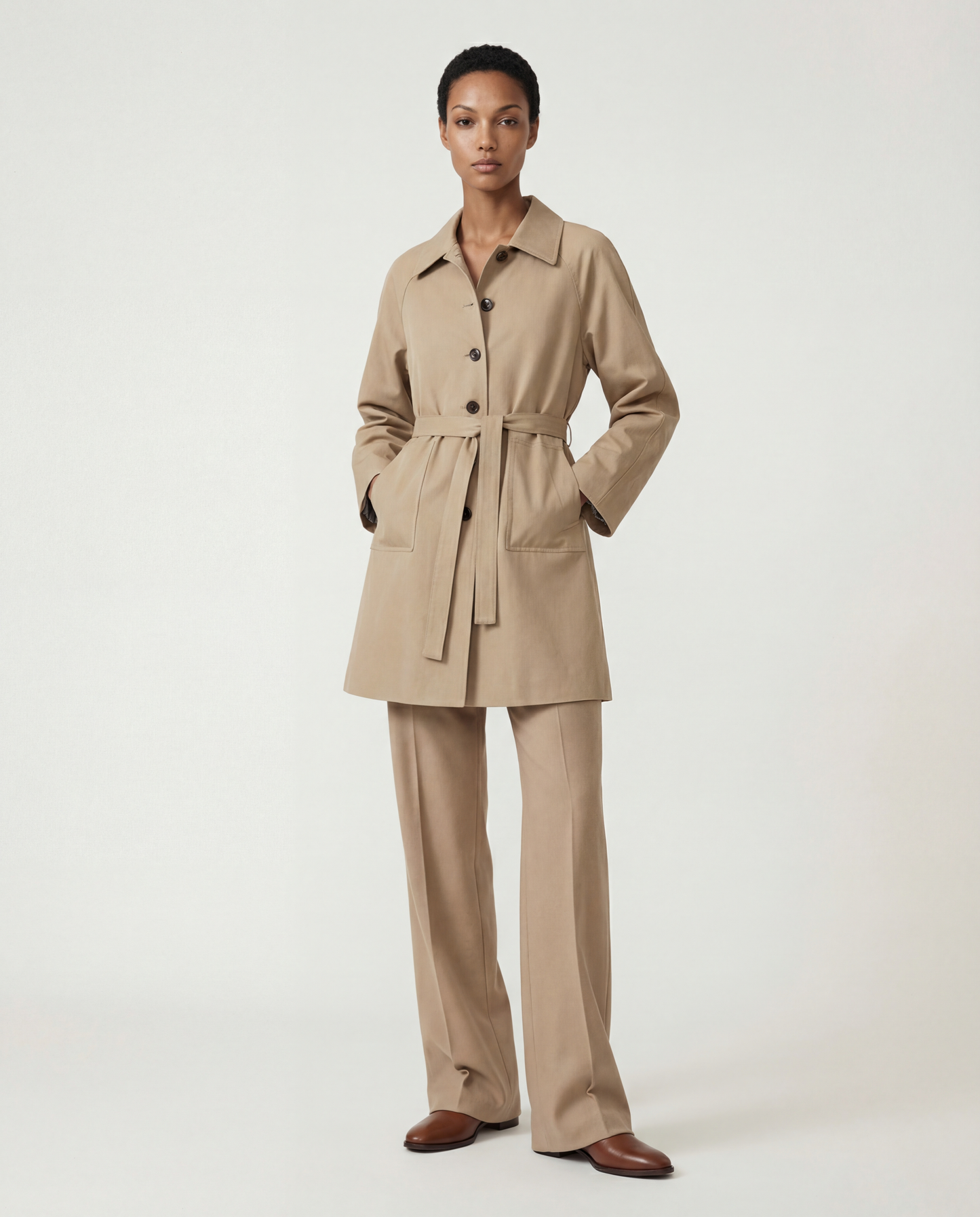 SELVANE light khaki straight-line trench coat with distinctive striped turn-up cuffs, showcasing controlled volume and fluid drape.