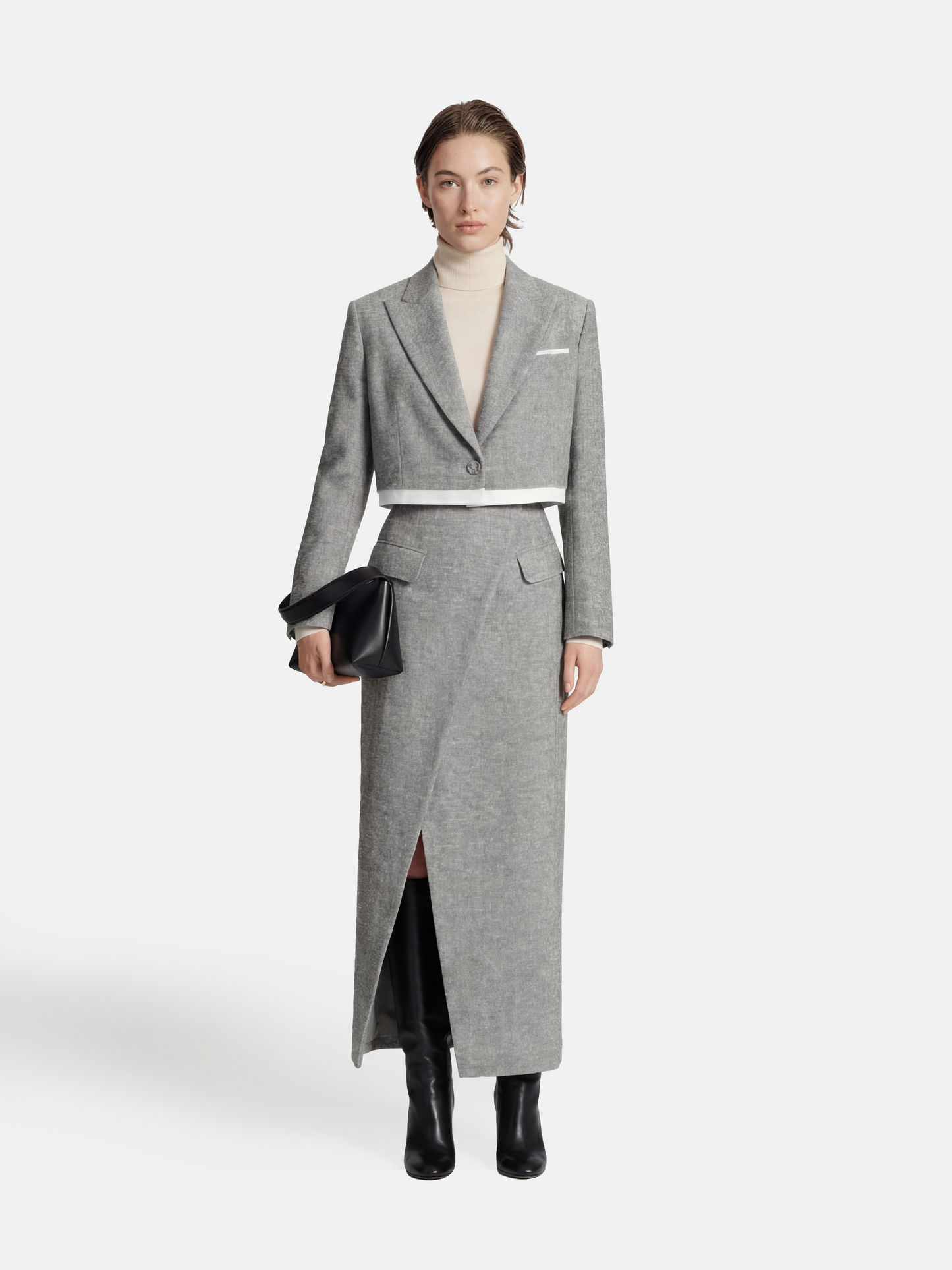 Cropped blazer and wrap midi skirt set in grey, featuring disciplined shoulders and fluid lines, inspired by volcanic terrain.