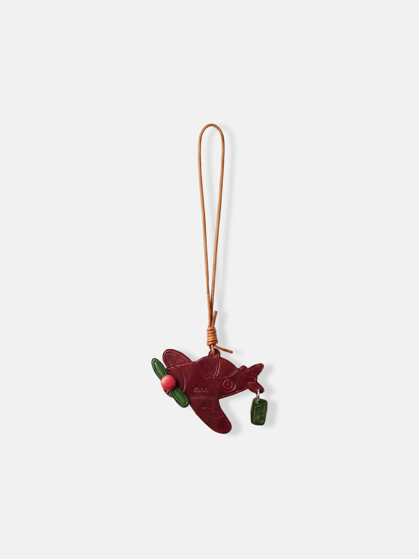 Polished metal Selvane Dream Plane Bag Charm, featuring a sleek aircraft silhouette and 'That's my dream' tag, symbolizing personal journeys.
