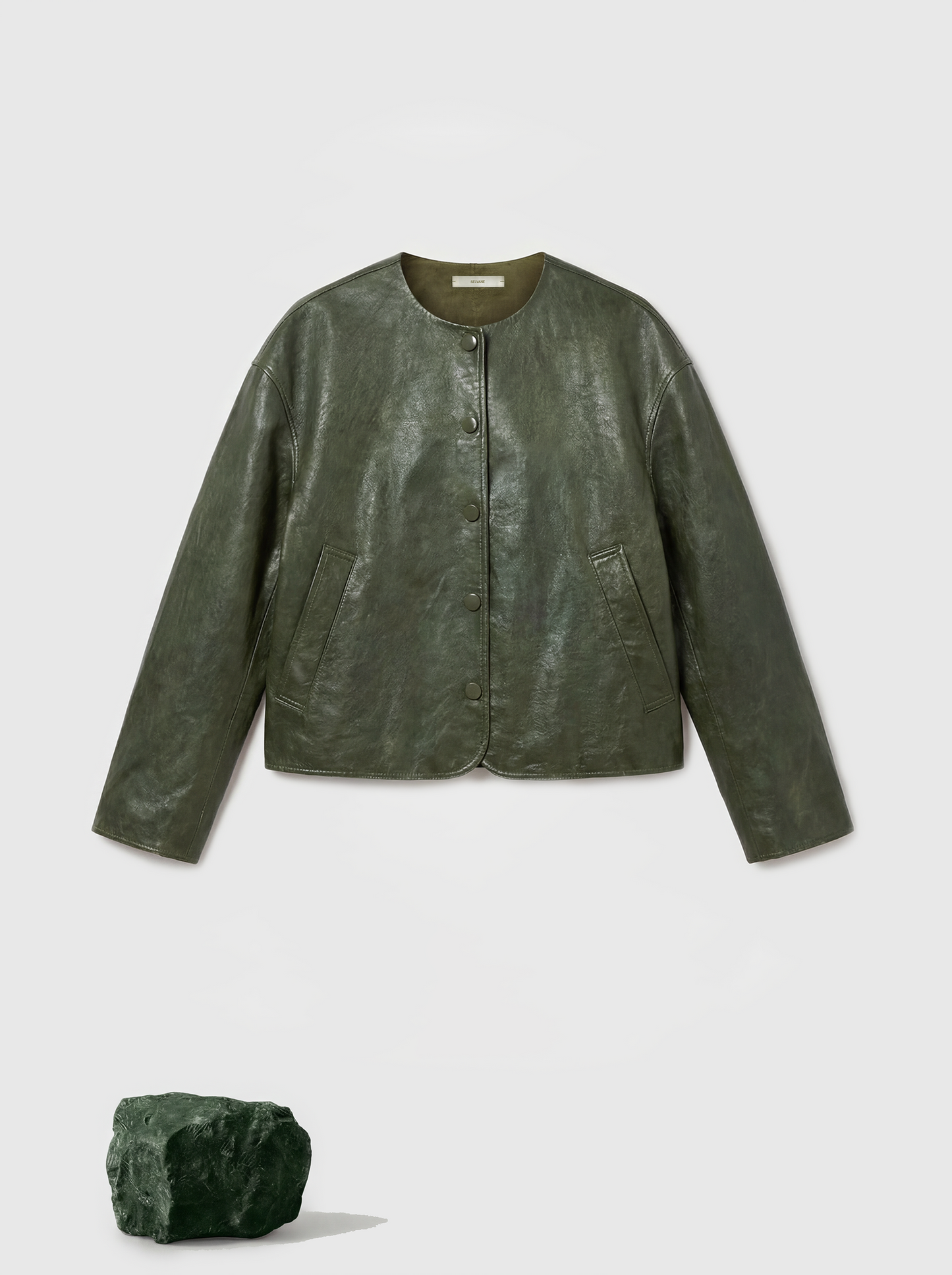Cropped olive lambskin jacket with a clean round neckline and tonal buttons, showcasing a precise, composed silhouette.
