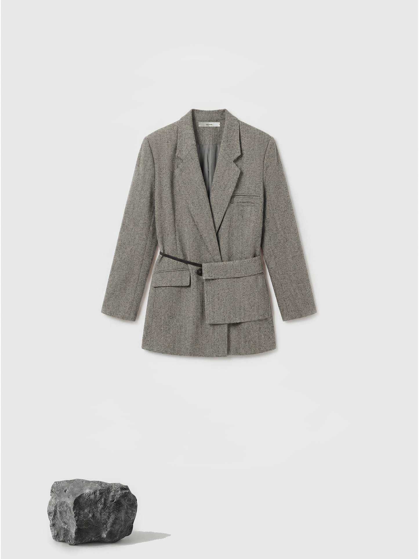 SELVANE heather grey tailored suit set, elongated body, shaped waist with asymmetric belt, on a model.