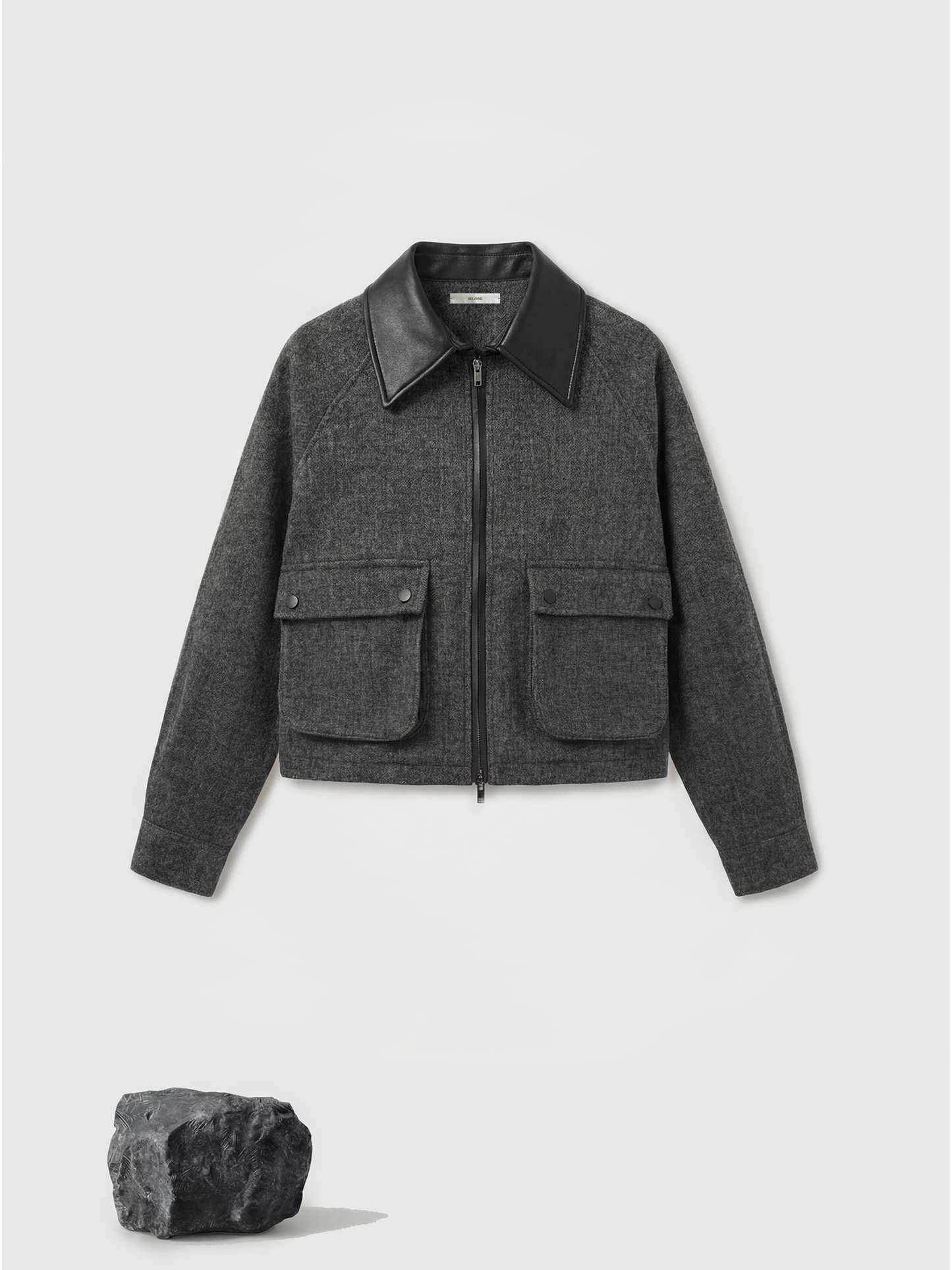 Charcoal wool-blend two-piece set featuring a cropped, boxy jacket with a sharp faux-leather contrast collar and a clean straight skirt.