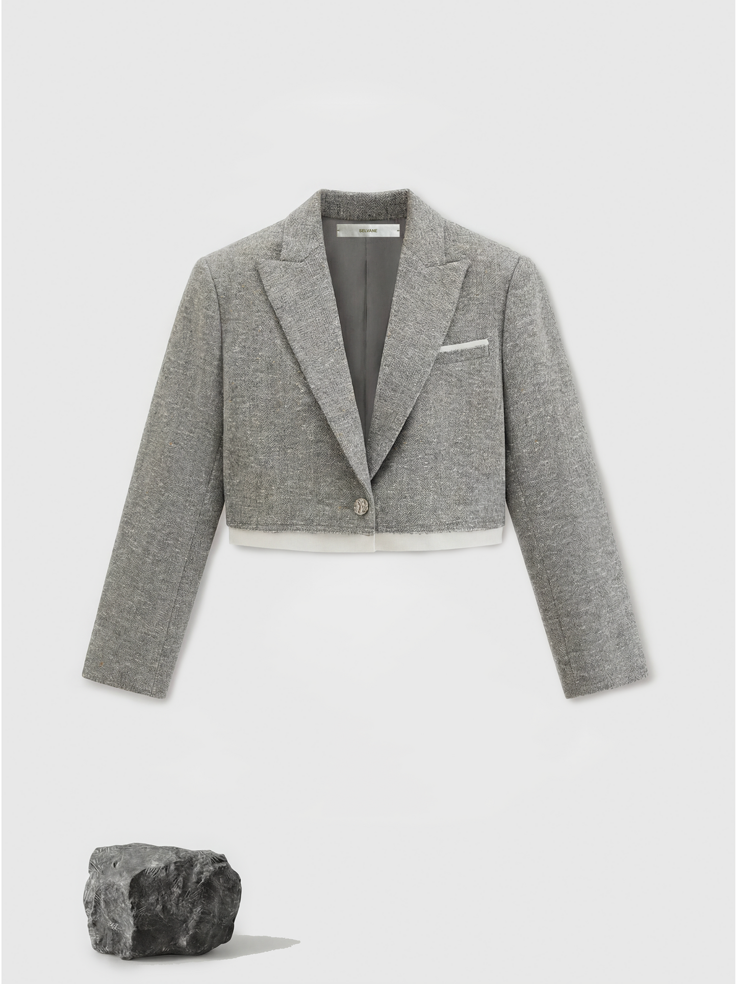 Cropped blazer and wrap midi skirt set in grey, featuring disciplined shoulders and fluid lines, inspired by volcanic terrain.