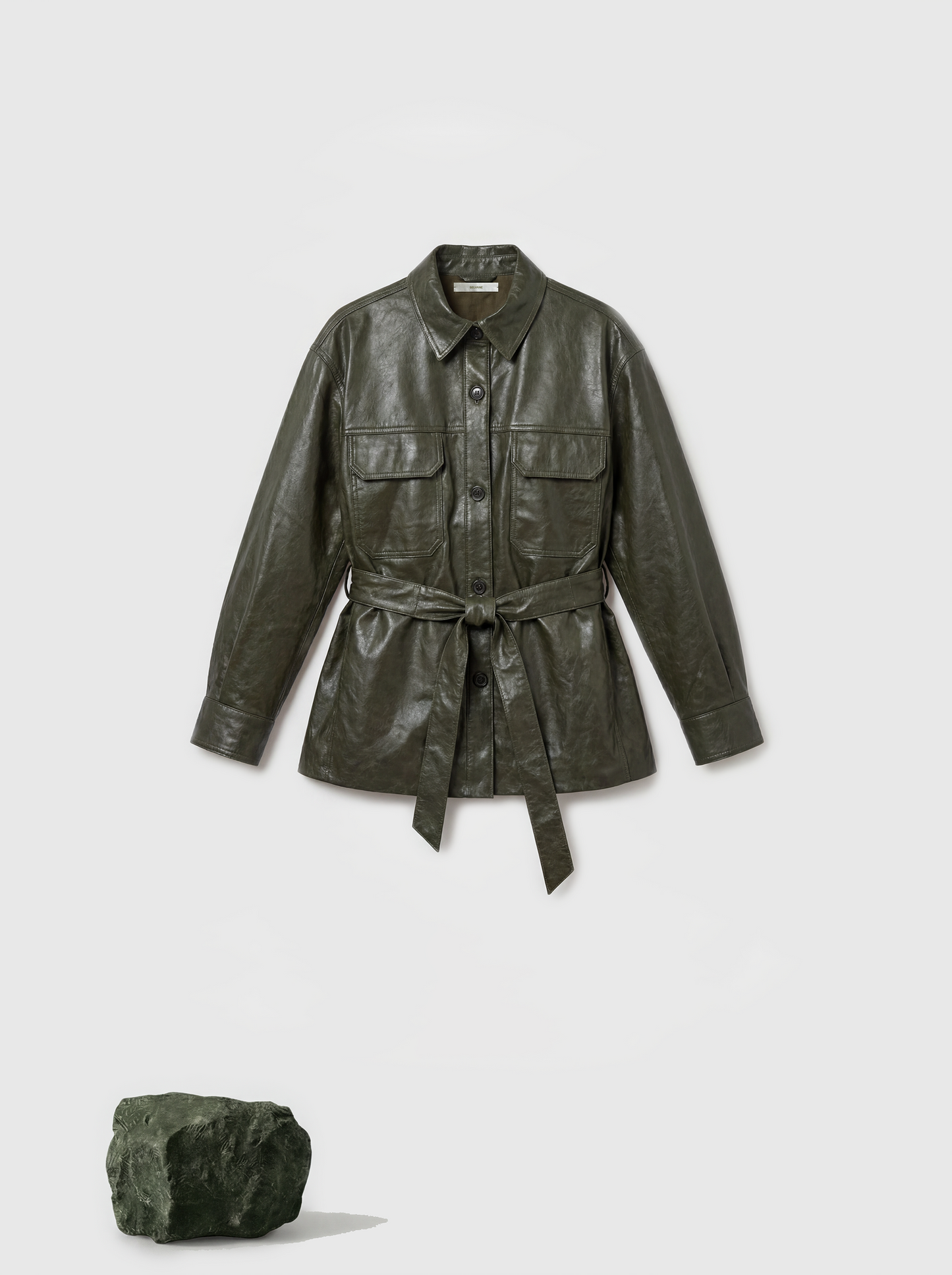 Olive lambskin belted shirt jacket with straight shoulders, cinched waist, and mid-thigh length, shown in motion.