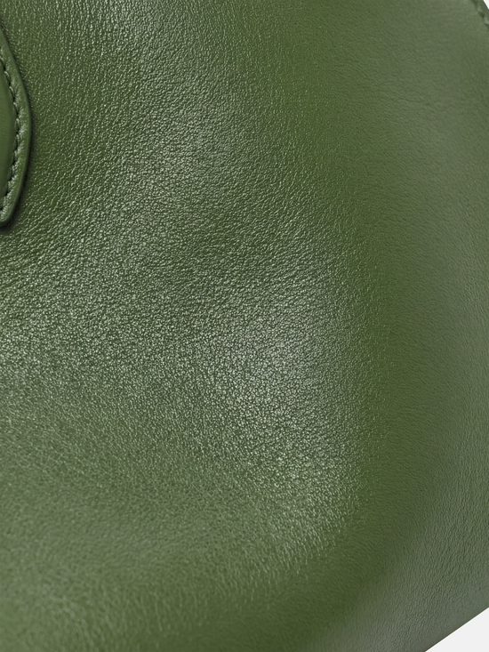 Structured deep navy saddle leather top handle bag with clean curves and elegant trapezoid shape.