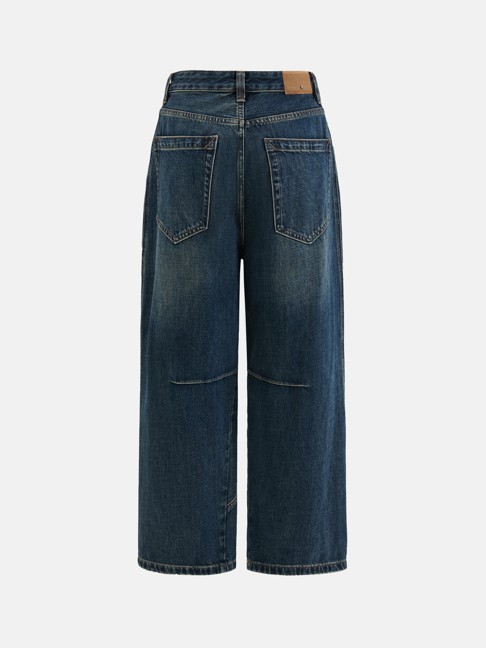 Model wearing high-rise SELVANE Sculpted Seam Wide-Leg Jeans in mid-wash pure cotton denim, showcasing the curved front seams.