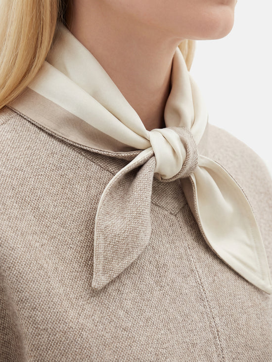 Muted apricot structured top by SELVANE, featuring a clean front seam, sculpted cuffs, and a detachable contrast scarf detail.