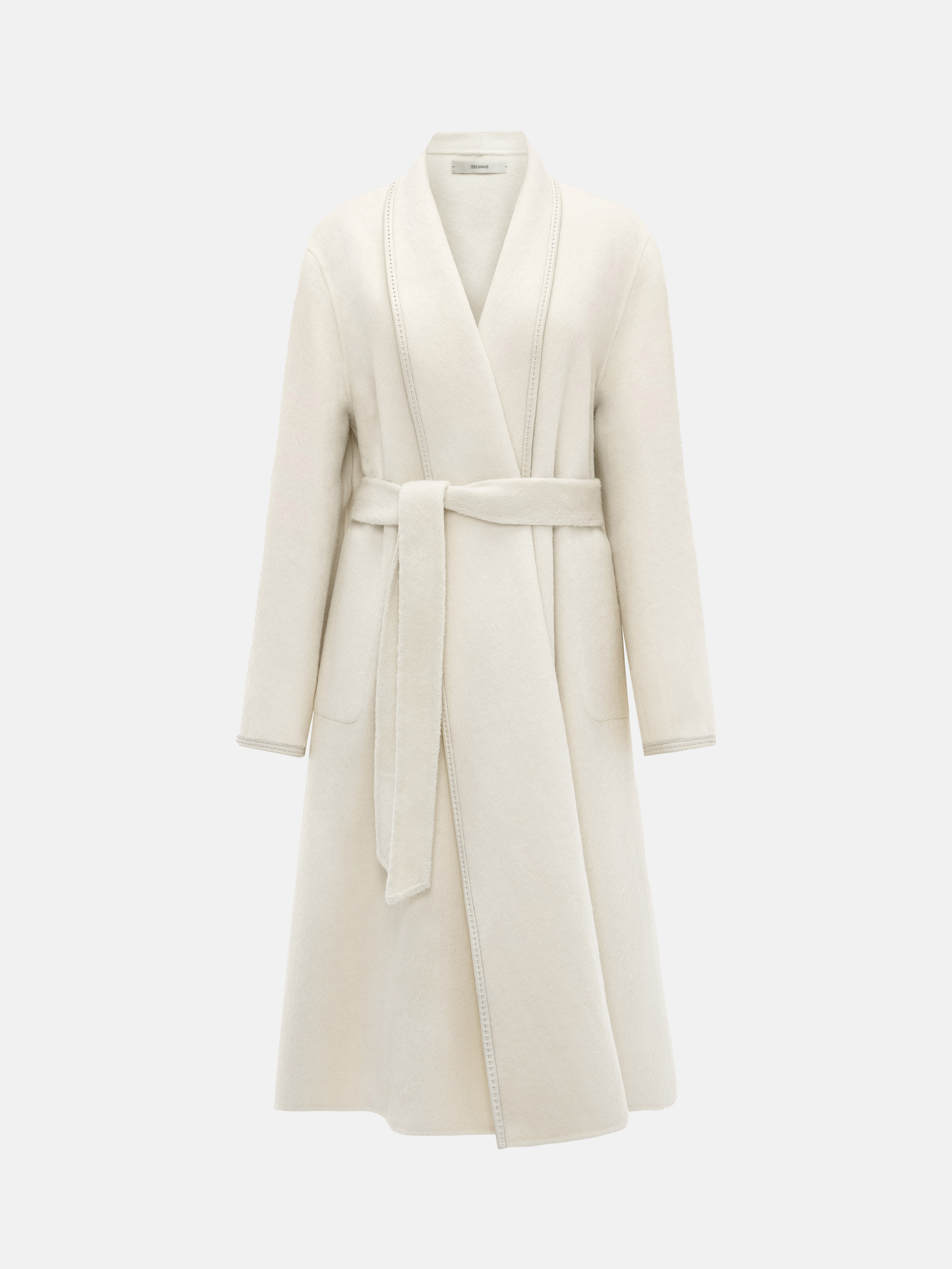 SELVANE Belted Wool Long Coat in a soft wool-llama blend, featuring a fluid drape and clean topstitched edges, worn by a model in a composed stance.