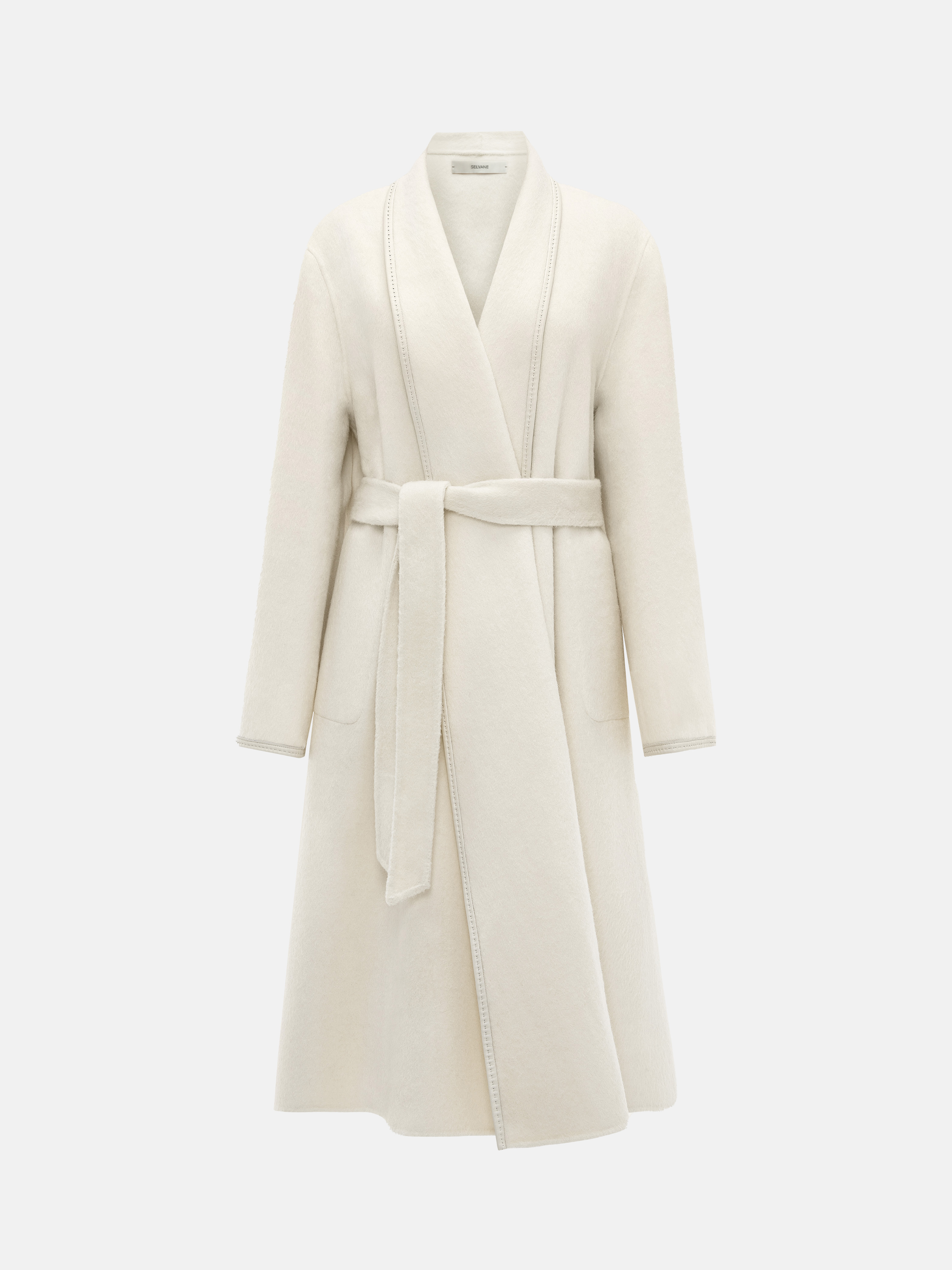 SELVANE Belted Wool Long Coat in a soft wool-llama blend, featuring a fluid drape and clean topstitched edges, worn by a model in a composed stance.