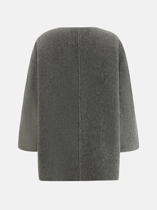 SELVANE asymmetric single-button wool coat in calm ivory, featuring a clear line and composed silhouette.