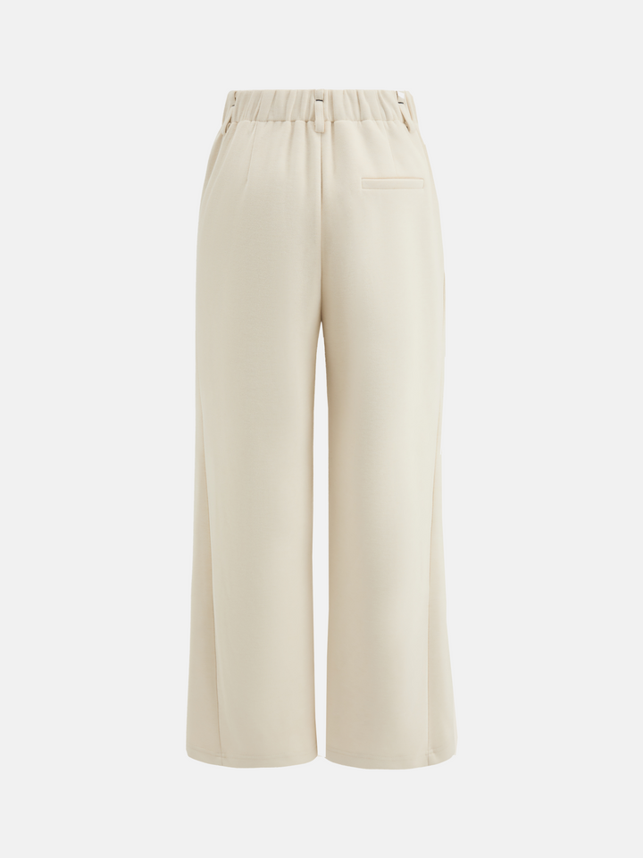 SELVANE Crease-Front Wide-Leg Trousers in a deep hue, showcasing crisp front creases and controlled volume, worn by a model in motion.