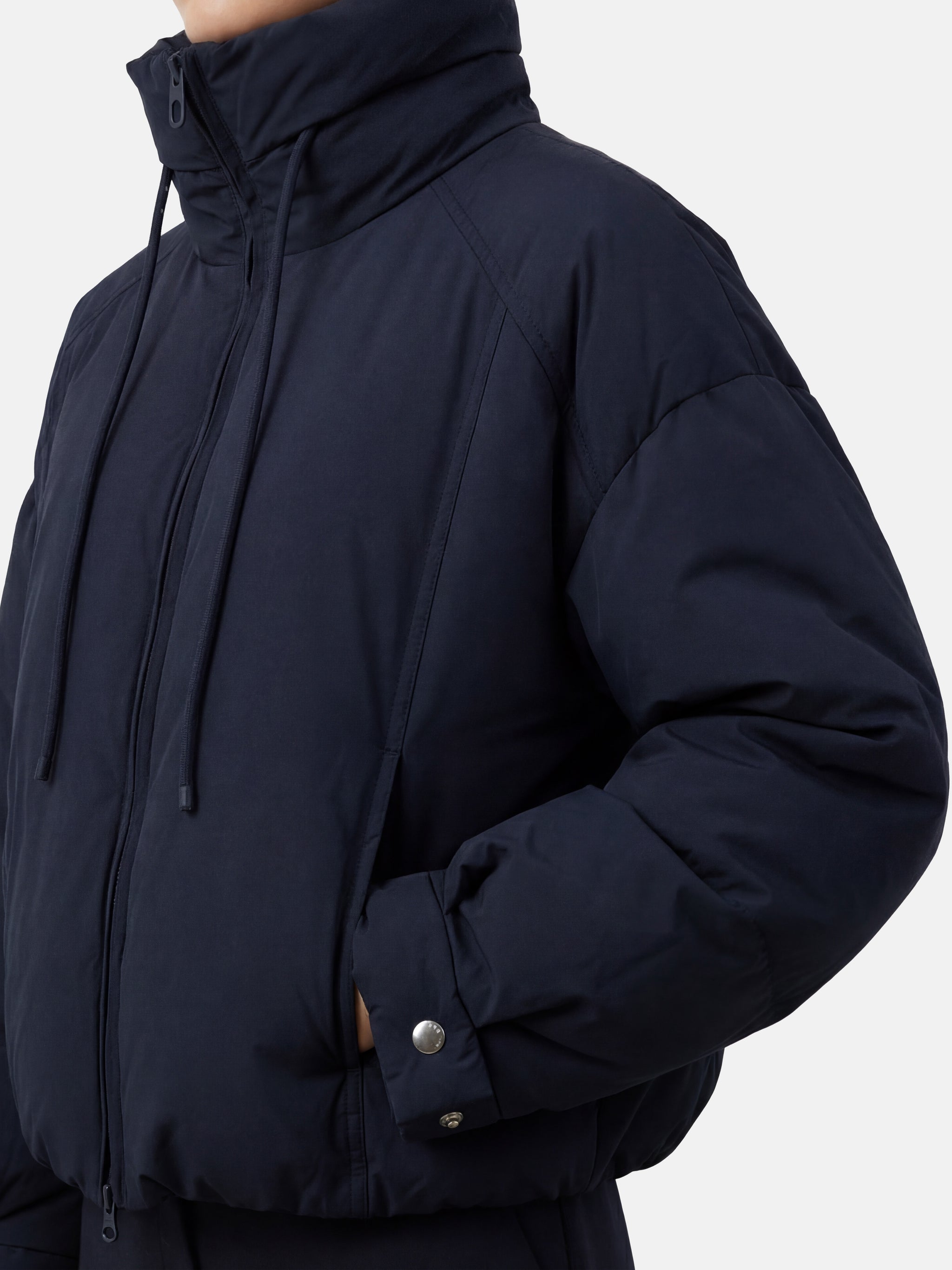 SELVANE High-Neck Bomber Down Jacket in black, featuring an exaggerated high collar and rounded silhouette, refined matte finish.