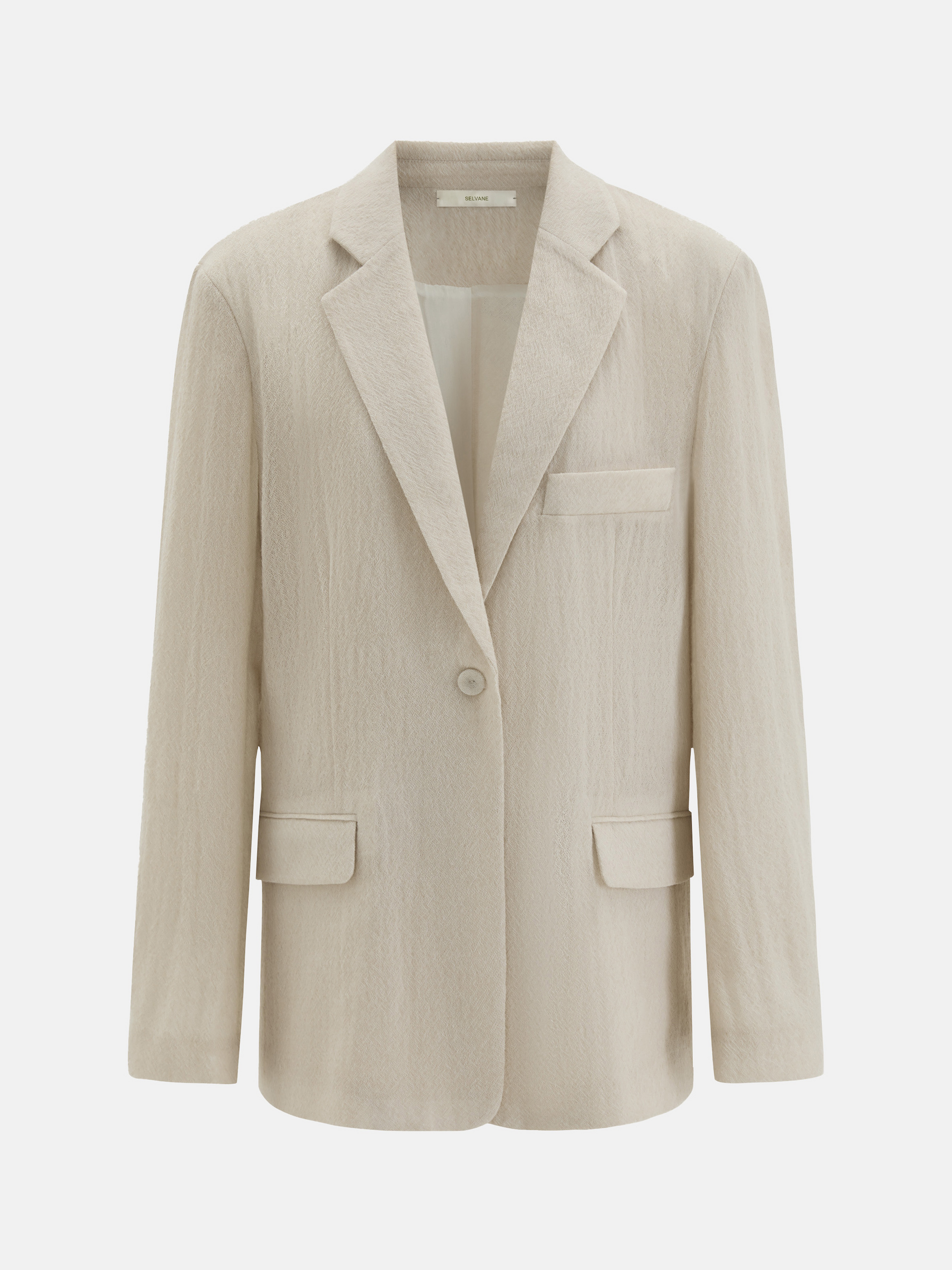 Structured worsted wool jacket with mulberry silk lining, tailored fit, shown on a model in a thoughtful pose.