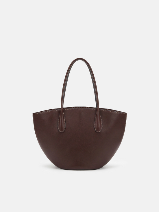 SELVANE Saddle Leather Crescent Tote Bag, featuring clean curvature, a grounded base, and long handles.