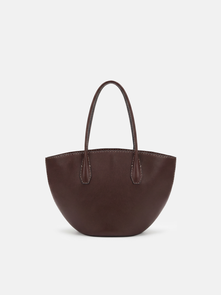 SELVANE Saddle Leather Crescent Tote Bag, featuring clean curvature, a grounded base, and long handles.