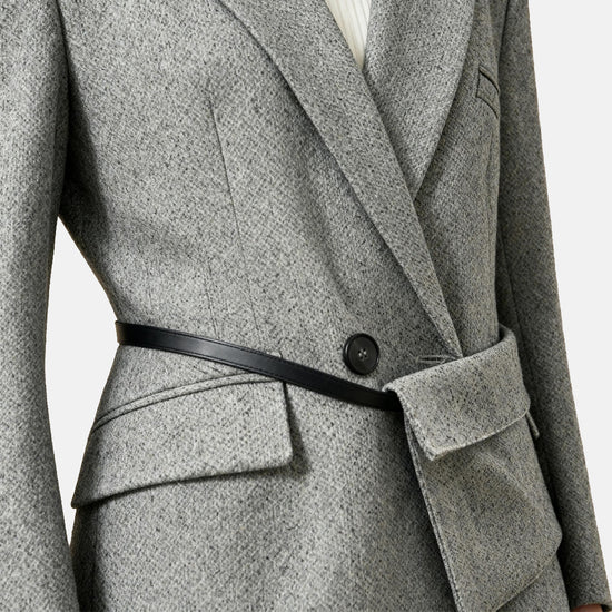 SELVANE heather grey tailored suit set, elongated body, shaped waist with asymmetric belt, on a model.