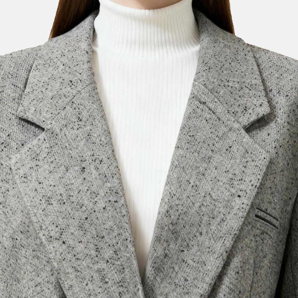 SELVANE heather grey tailored suit set, elongated body, shaped waist with asymmetric belt, on a model.