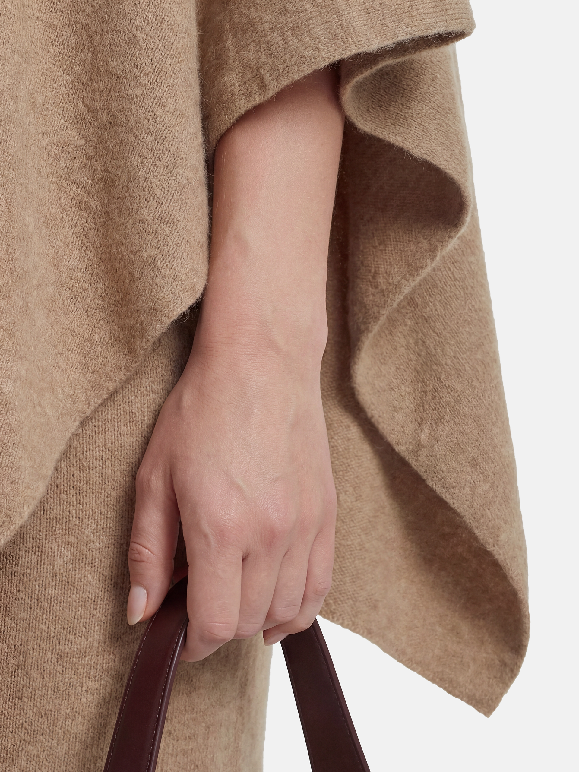 Pure cashmere button-neck cape in warm camel with an elongated, asymmetric drape and high ribbed neck.