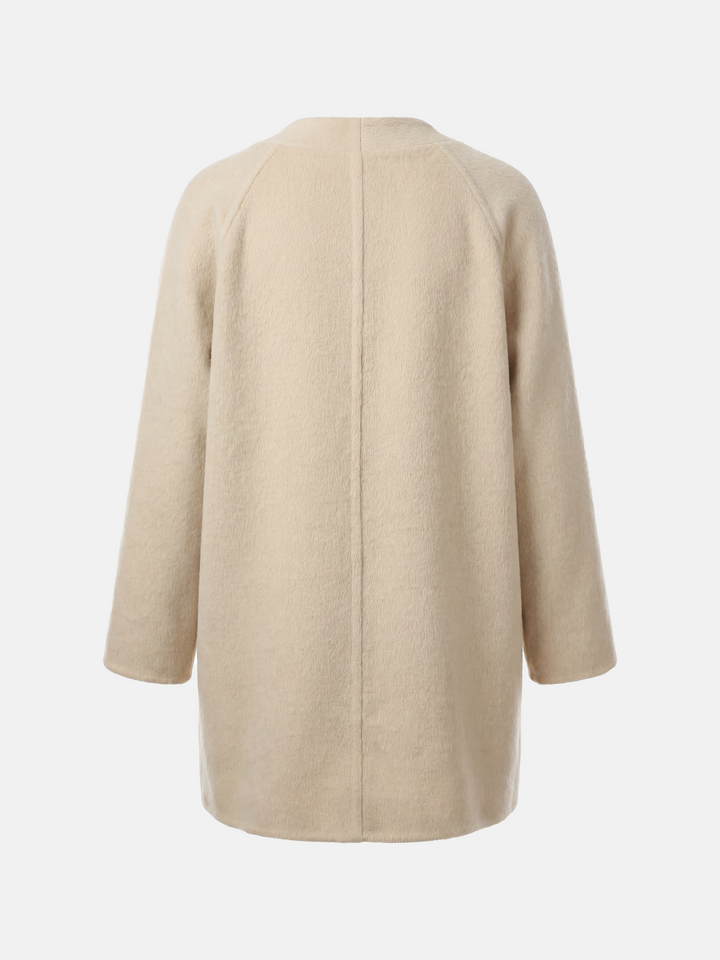 SELVANE double-breasted camel hair coat with raglan sleeves, oversized fit, above-knee length, warm ivory tone.