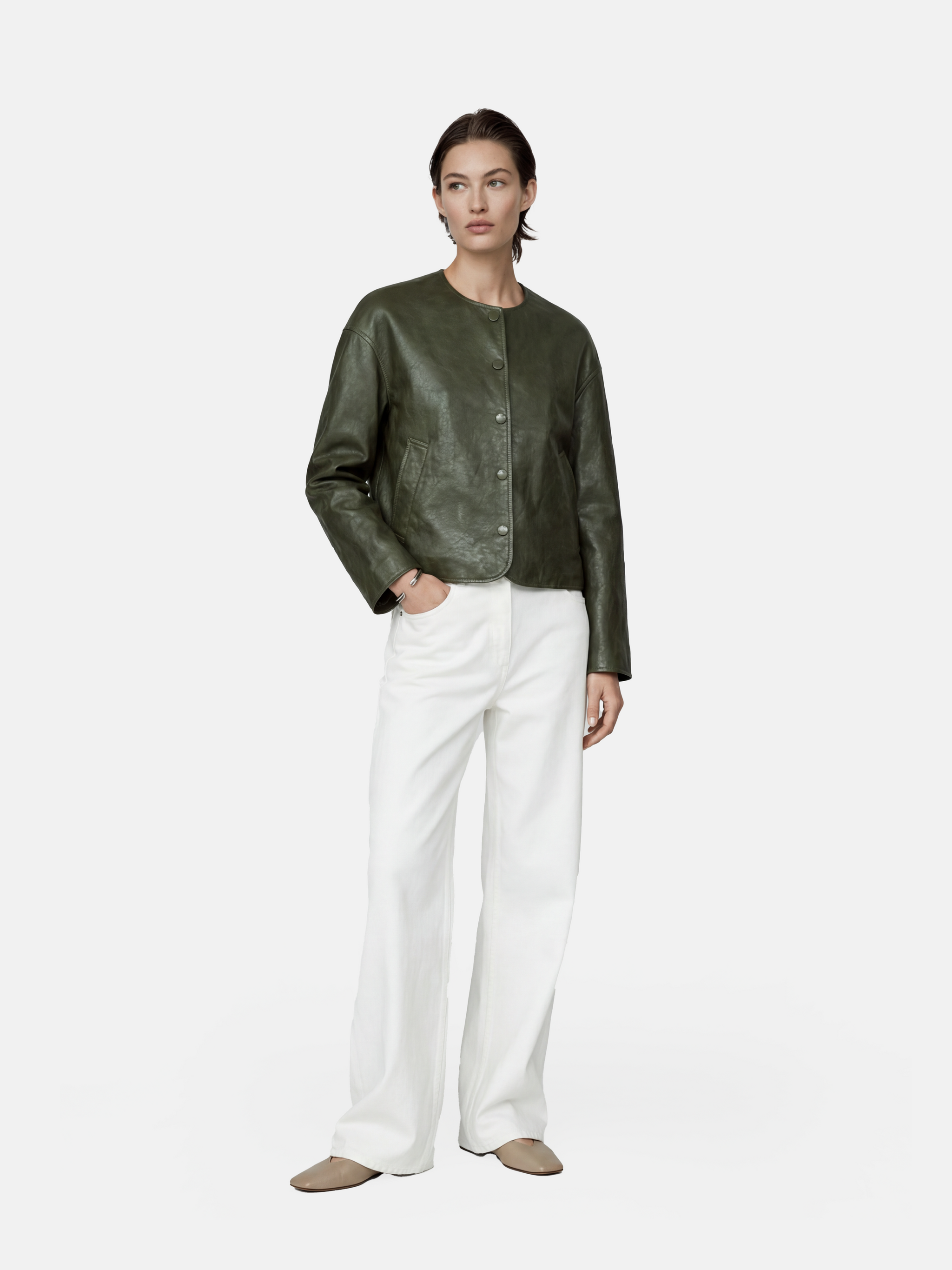 Cropped olive lambskin jacket with a clean round neckline and tonal buttons, showcasing a precise, composed silhouette.