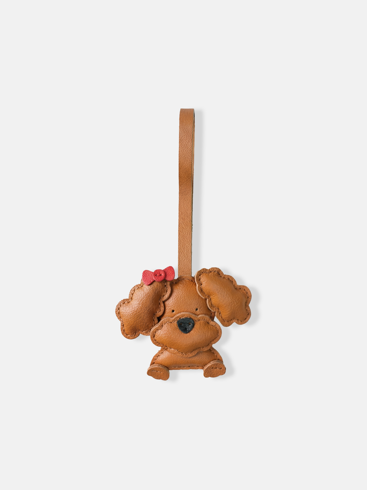 Selvane Bow Poodle bag charm in minimalist leather, featuring a sculpted poodle figure with a small, precise bow.