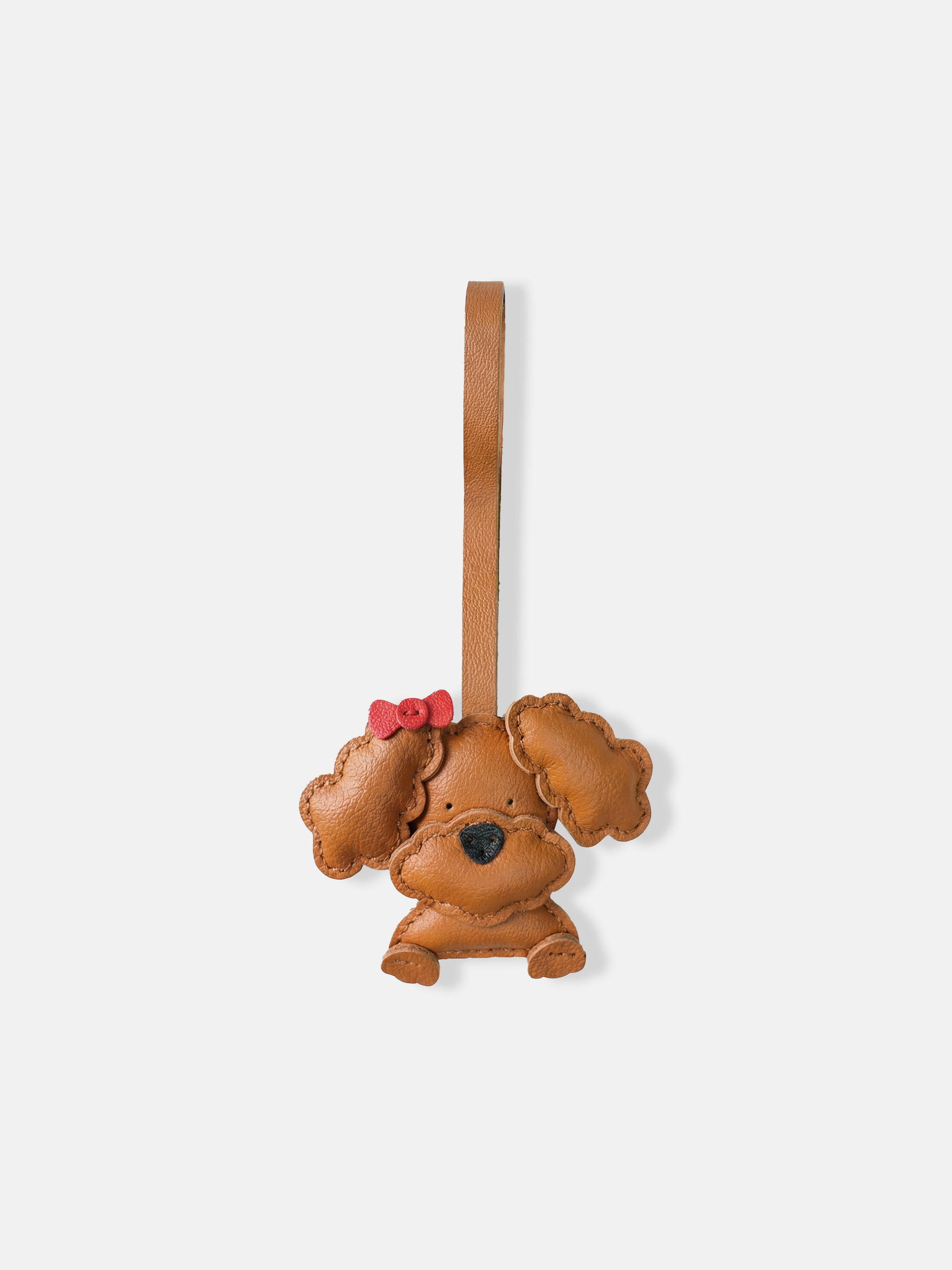 Selvane Bow Poodle bag charm in minimalist leather, featuring a sculpted poodle figure with a small, precise bow.