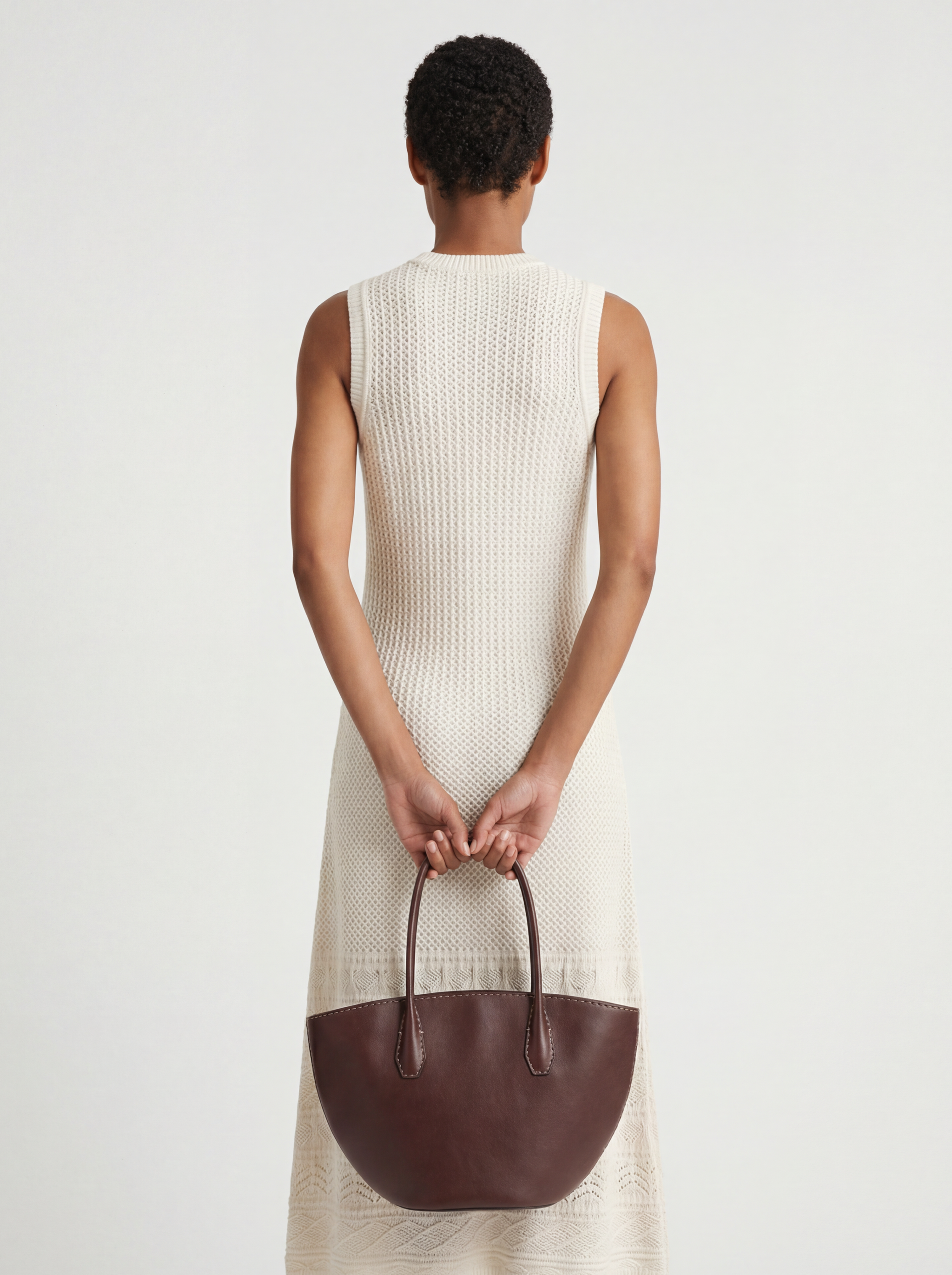 SELVANE Saddle Leather Crescent Tote Bag, featuring clean curvature, a grounded base, and long handles.