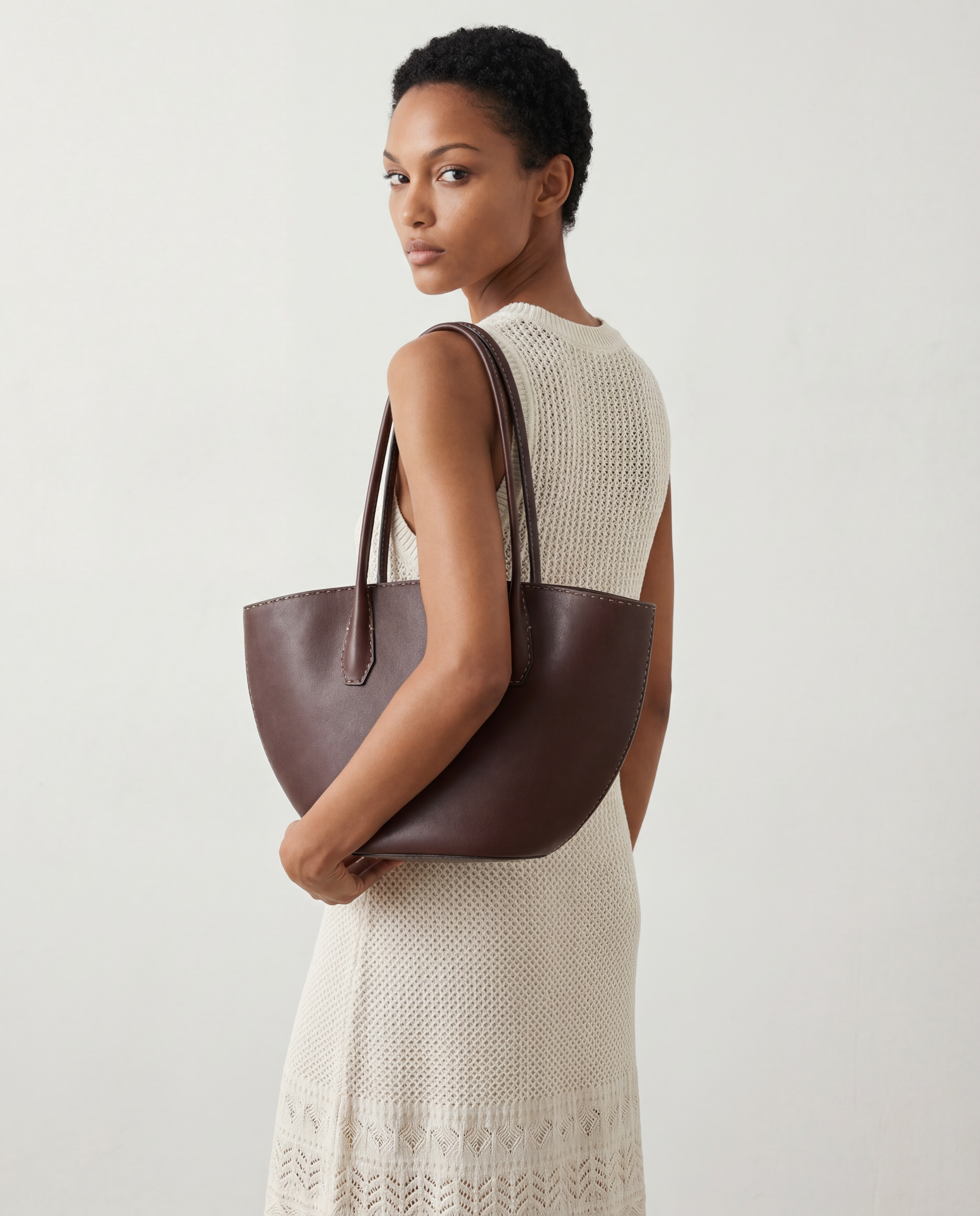 SELVANE Saddle Leather Crescent Tote Bag, featuring clean curvature, a grounded base, and long handles.