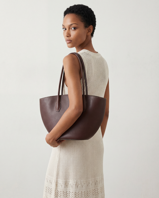 SELVANE Saddle Leather Crescent Tote Bag, featuring clean curvature, a grounded base, and long handles.
