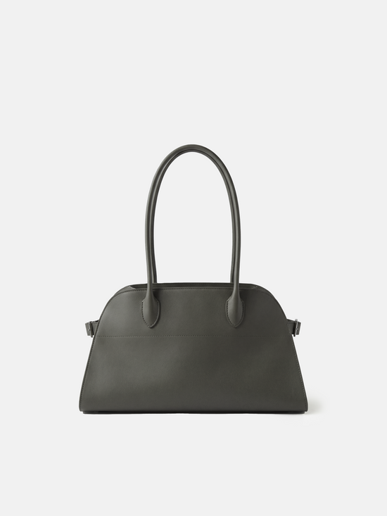 Structured deep navy saddle leather top handle bag with clean curves and elegant trapezoid shape.