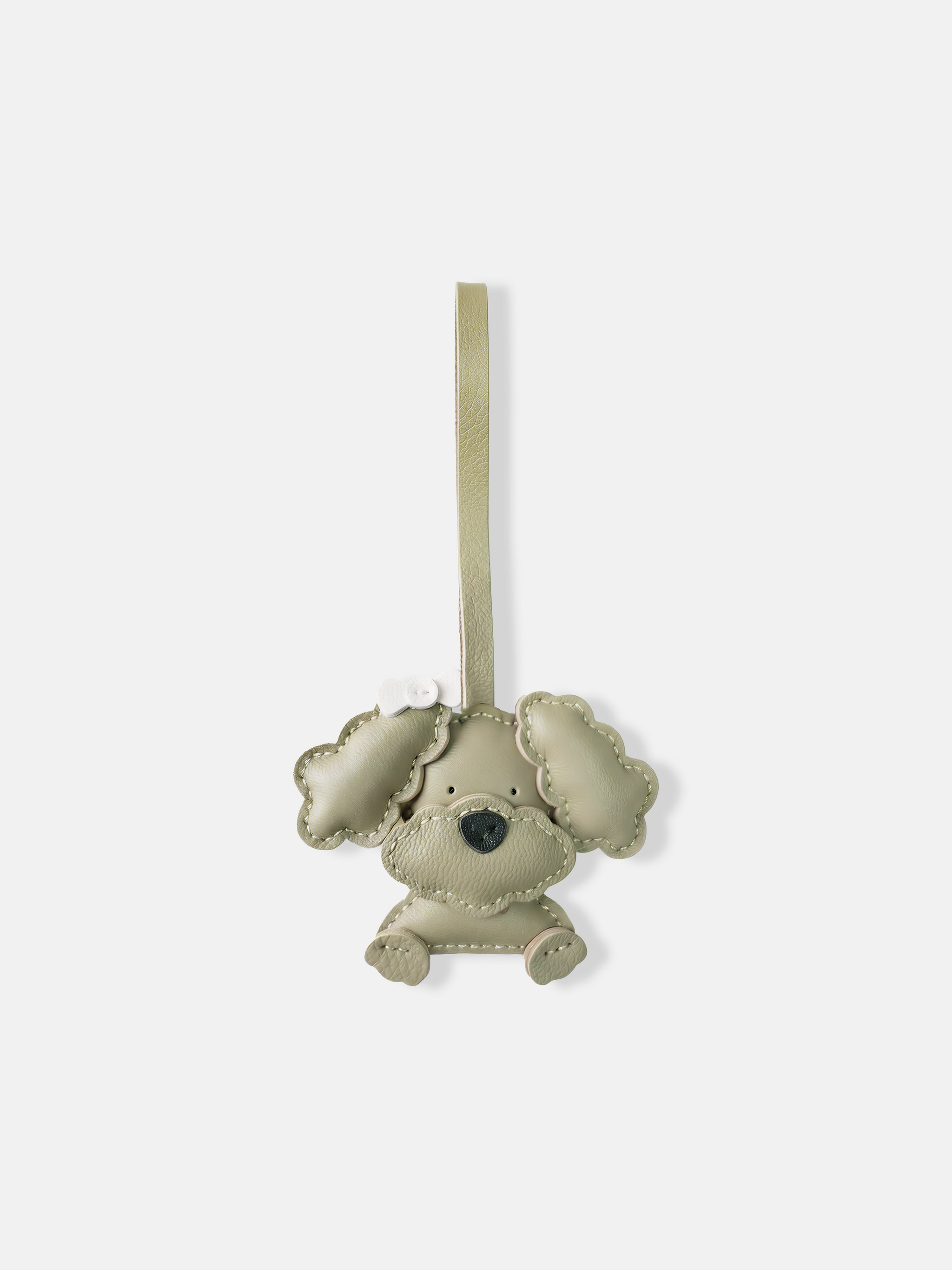 Selvane Bow Poodle bag charm in minimalist leather, featuring a sculpted poodle figure with a small, precise bow.