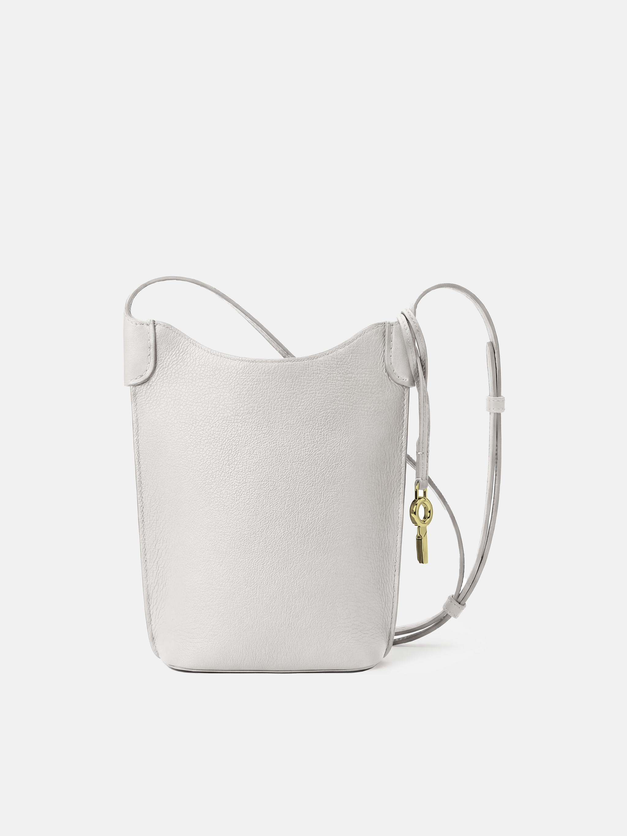 SELVANE Leather Mini Bucket Bag in Bonaudo cow leather, featuring soft vertical lines, a curved top, and long strap, sitting neatly.