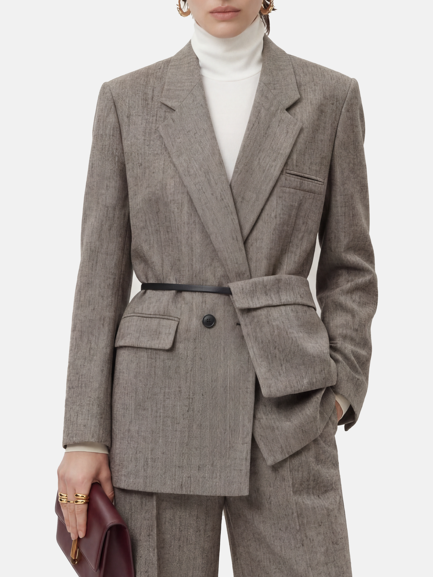 SELVANE heather grey tailored suit set, elongated body, shaped waist with asymmetric belt, on a model.