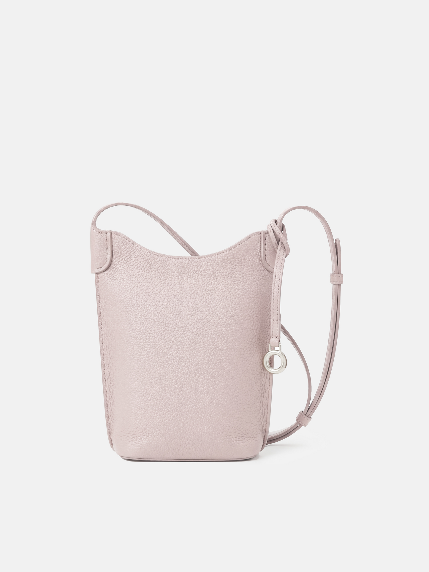 SELVANE Leather Mini Bucket Bag in Bonaudo cow leather, featuring soft vertical lines, a curved top, and long strap, sitting neatly.