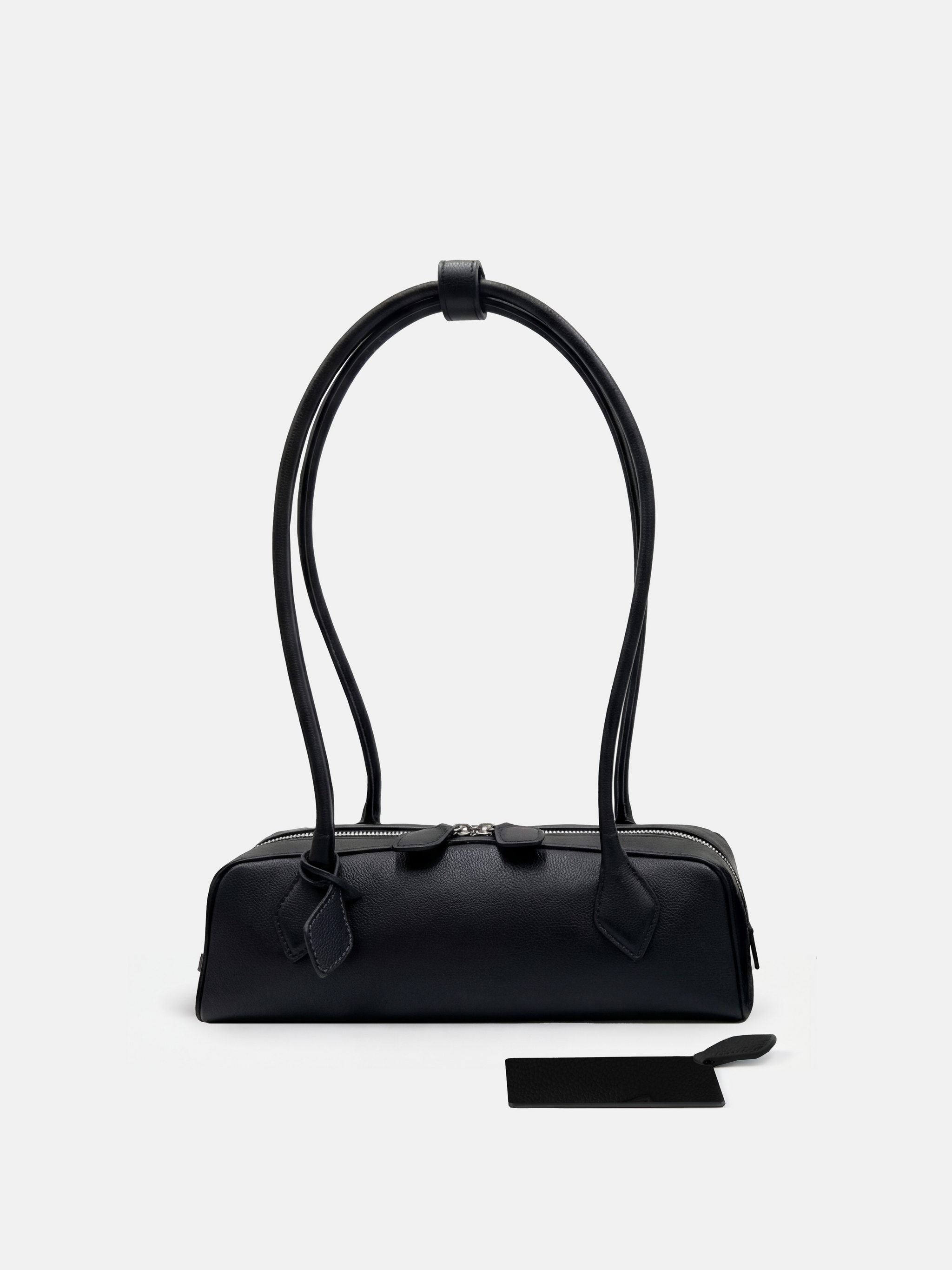 SELVANE Sausage Zipper Shoulder Bag in custom leather, longline, low-profile, softly rounded, with a streamlined zipper top.